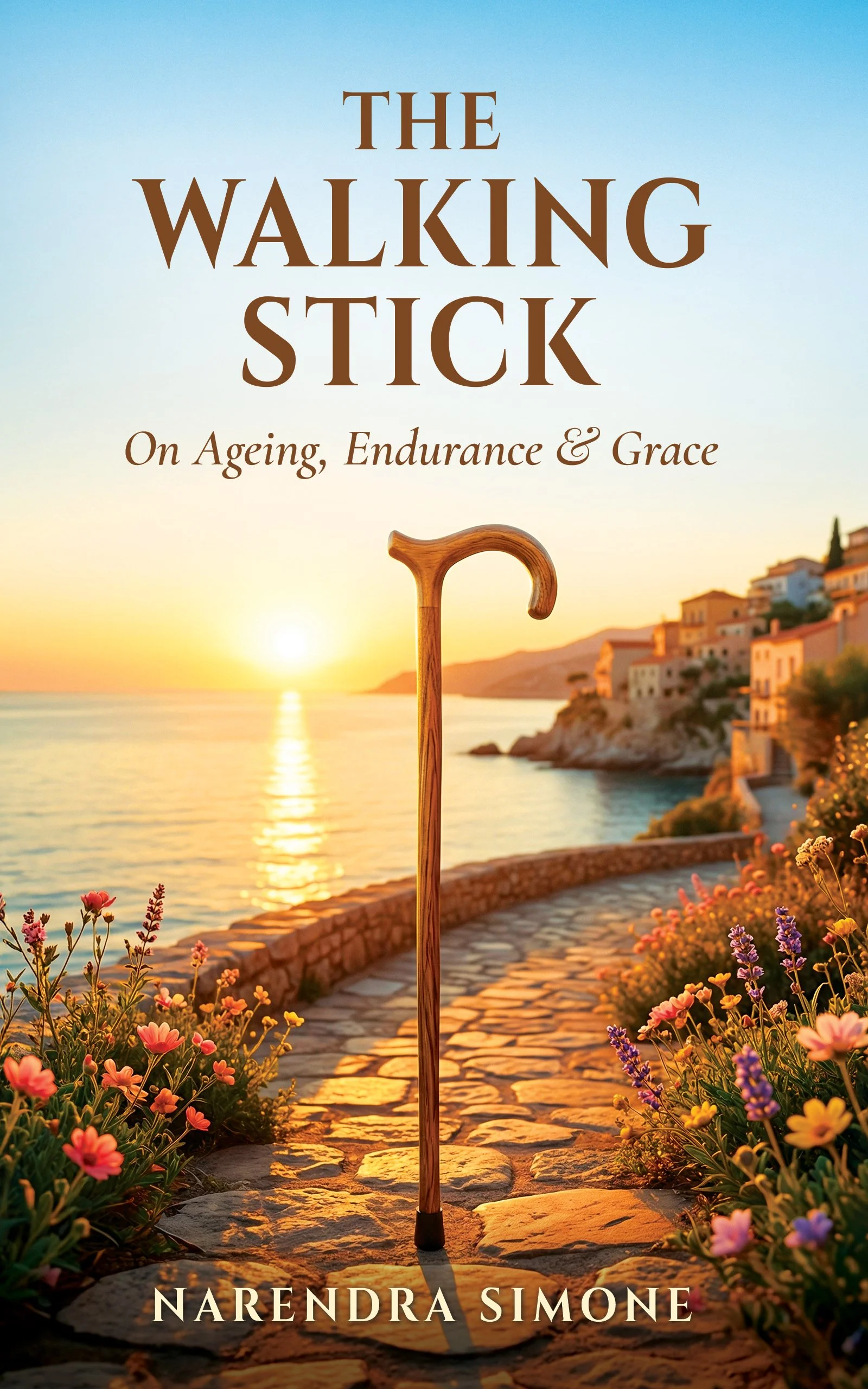 Book cover of 'The Walking Stick: On Aging, Endurance & Grace' by Narendra Simone. The cover features a walking cane in front of a scenic coastal landscape at sunset, with flowers lining a stone pathway.