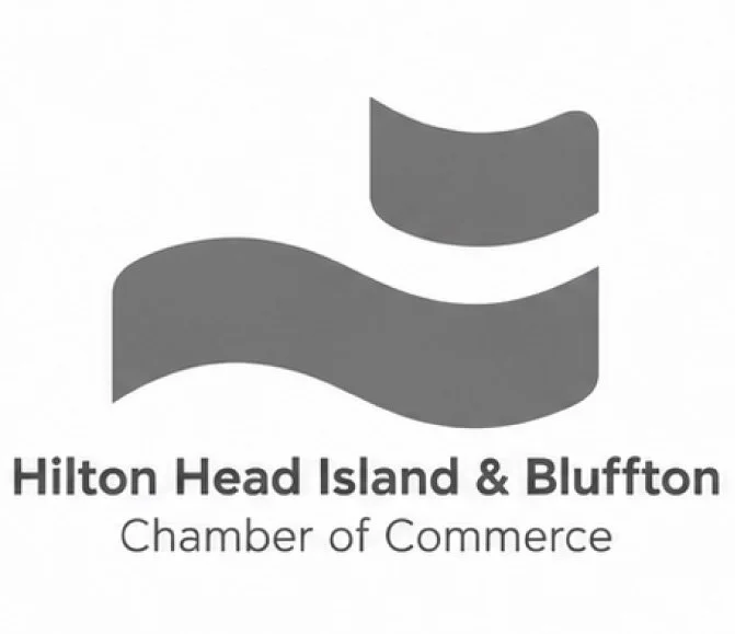 Logo of Hilton Head Island & Bluffton Chamber of Commerce with wavy flag icon in grey.