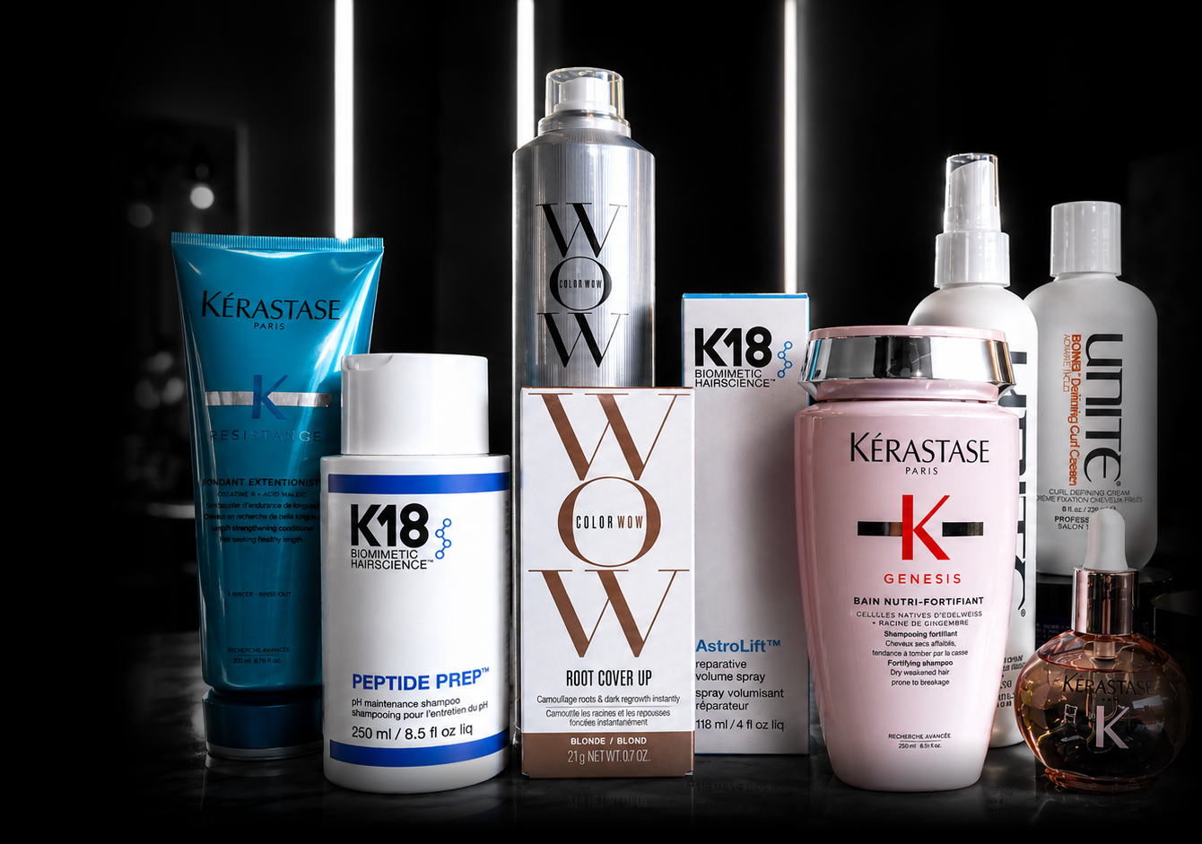 Collection of hair care products including shampoos, conditioners, spray, root cover, and styling products from Kerastase and K18 brands.