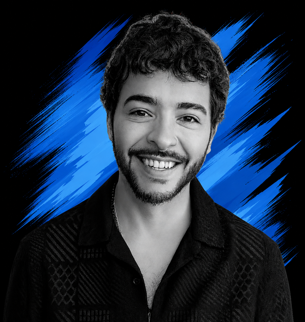 Black and white portrait of a young man smiling, with a blue paint stroke background.