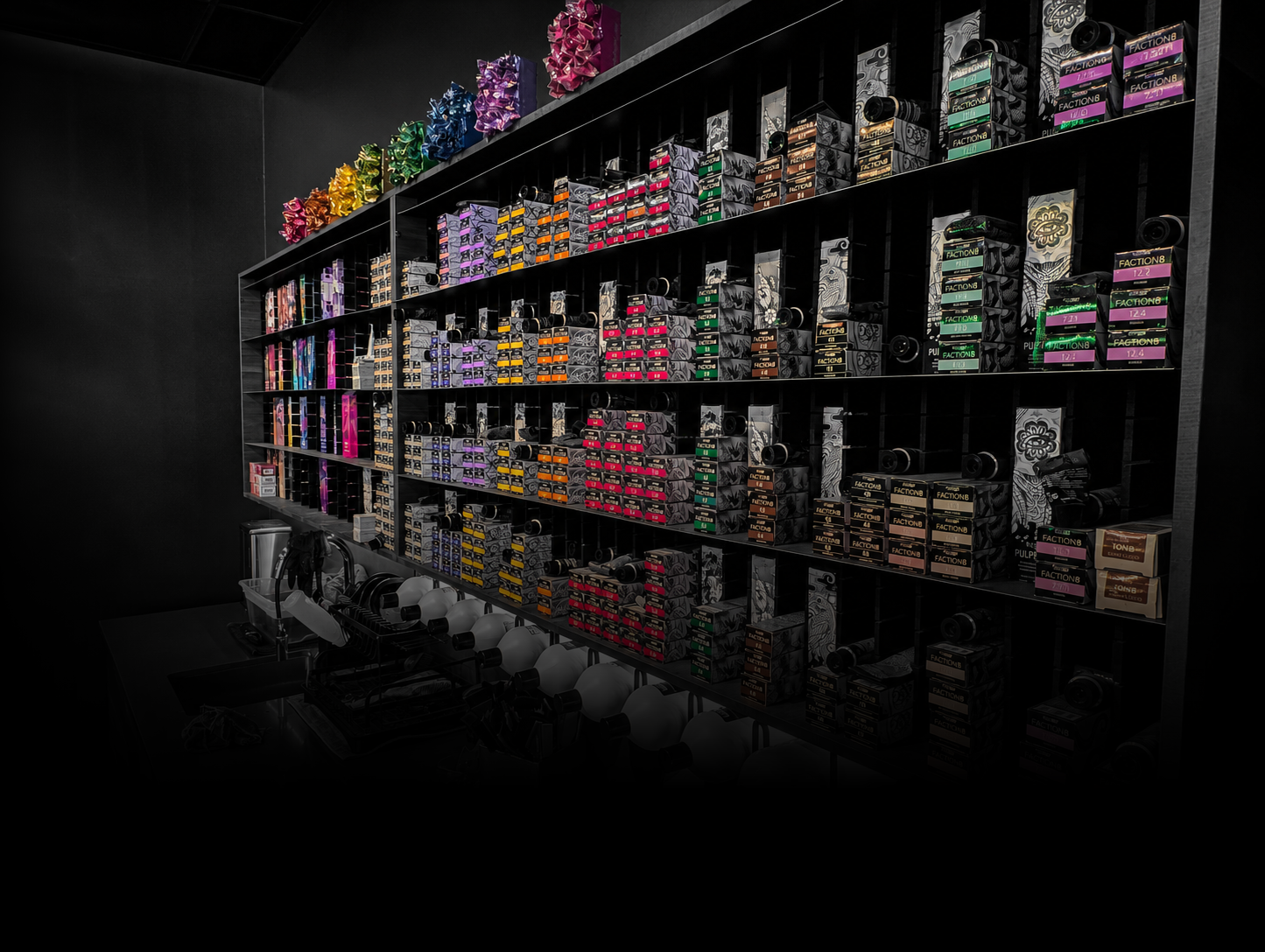 Colorful shelves stocked with various boxes of ink or toner cartridges, organized by color and type, in a retail store.