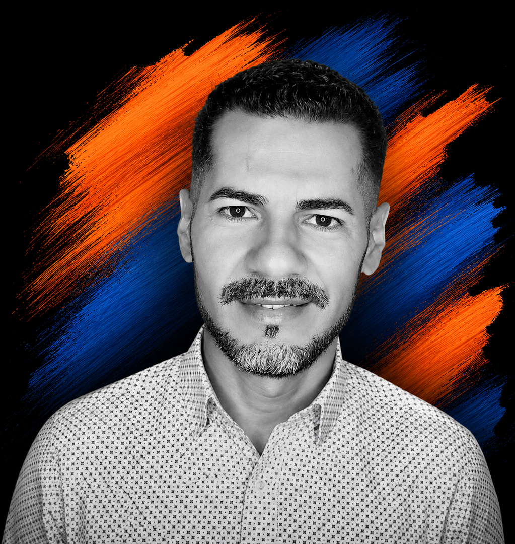 Black and white portrait of a man with short dark hair and a beard, wearing a patterned shirt, with an abstract background of orange and blue brush strokes.