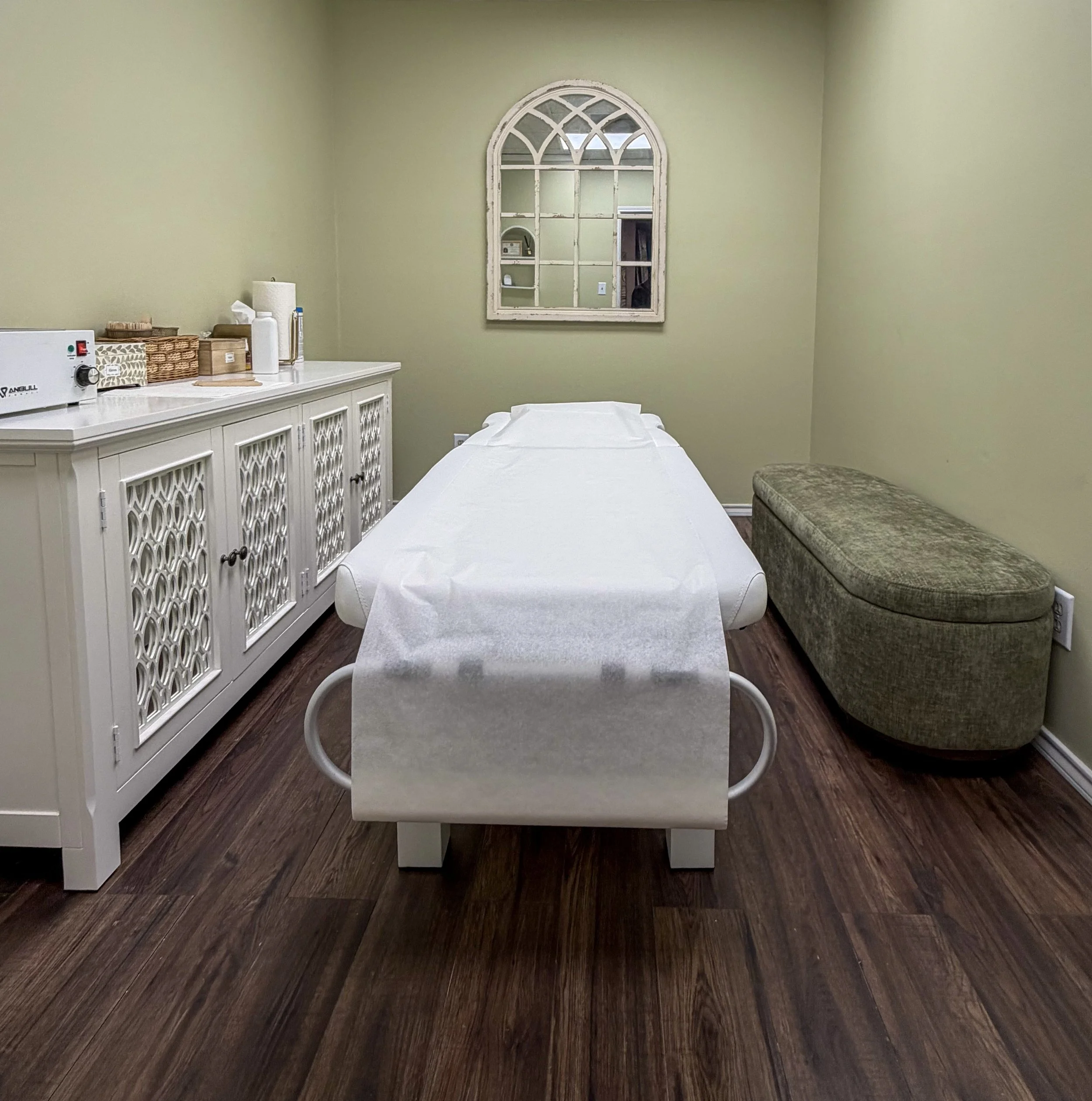 Clean and comfortable private waxing treatment room at Waxing by Paula in Beaumont, TX, featuring a prepared esthetician table and modern salon decor.
