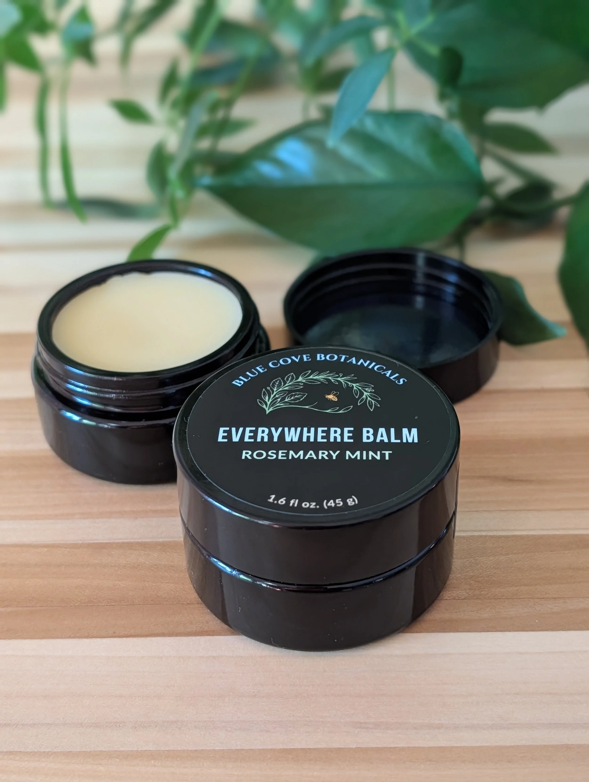 Open jar of Blue Cove Botanicals Everywhere Balm Rosemary Mint showing the balm texture inside the container.