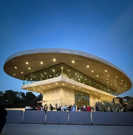 Modern Los Angeles museum building lit up at dusk