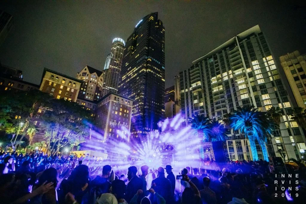 Crowd watching a light installation beneath downtown Los Angeles skyscrapers at night, Pershing Square, Inner Visions 2019