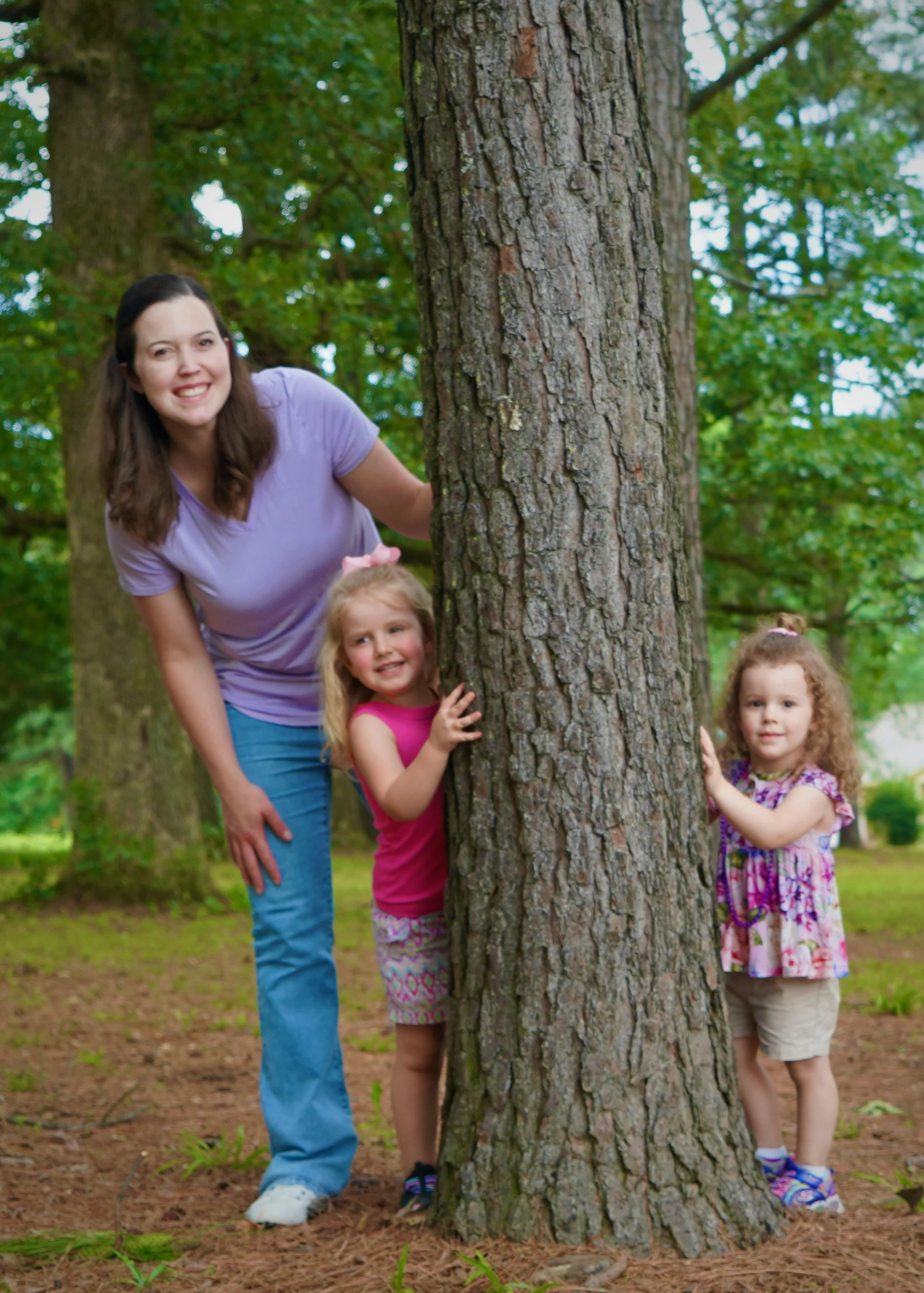 Children and a Rooted Kids occupational therapist enjoying outdoor play.