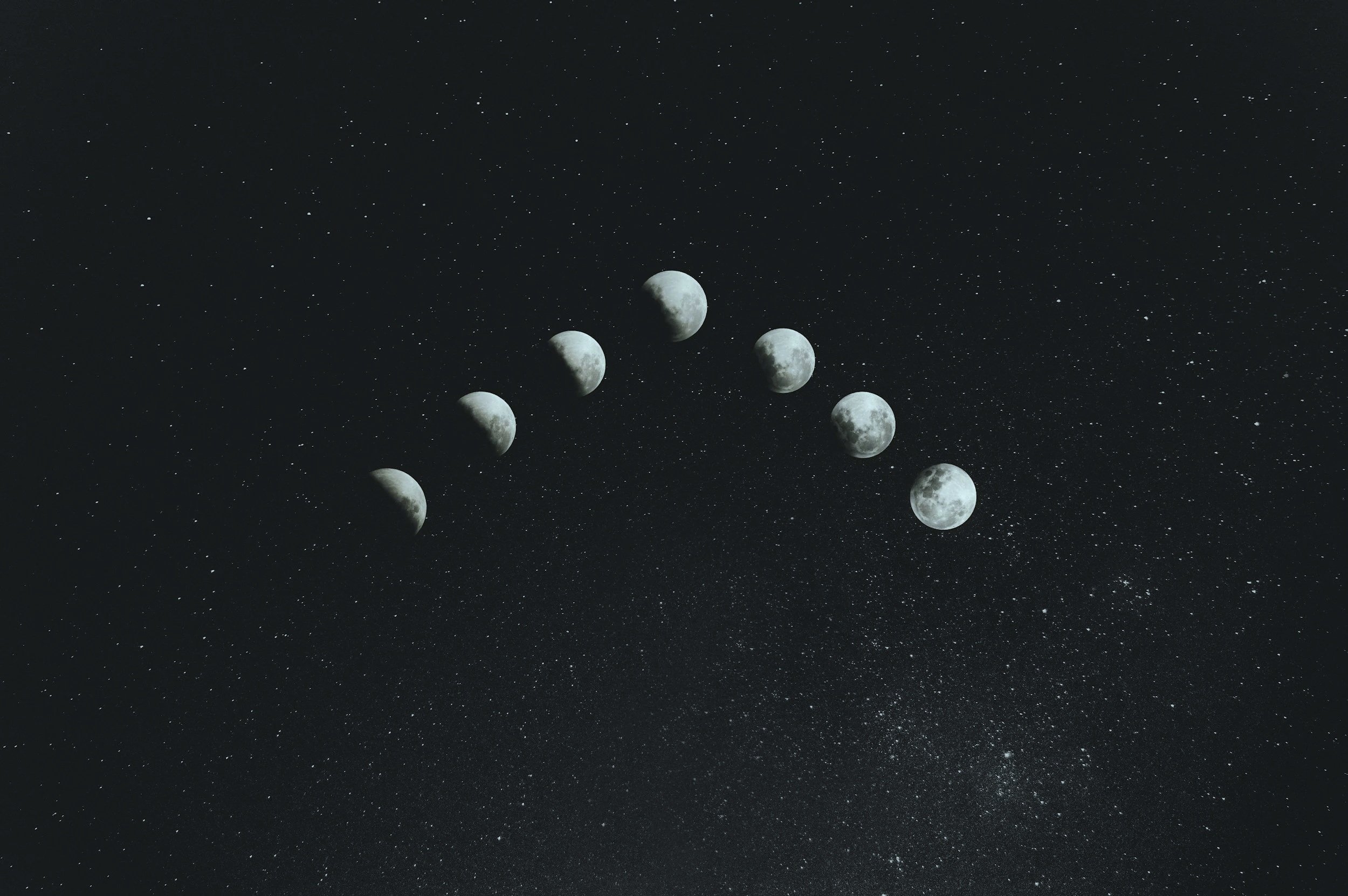 A photograph of the moon in various phases against a starry night sky.