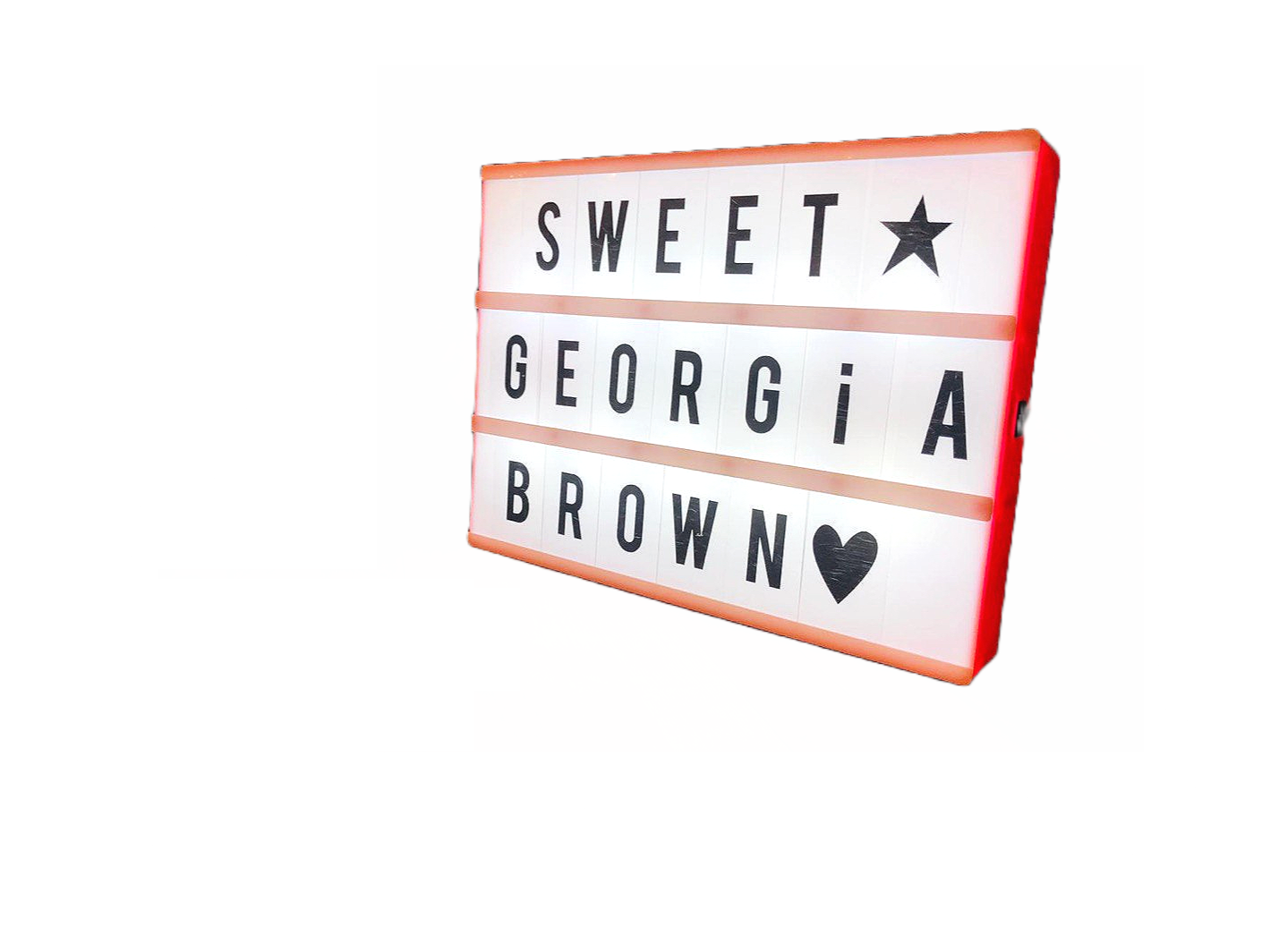 Lightbox sign displaying the words 'SWEET GEORGIA BROWN' with a star and a heart symbol, illuminated against a dark background.