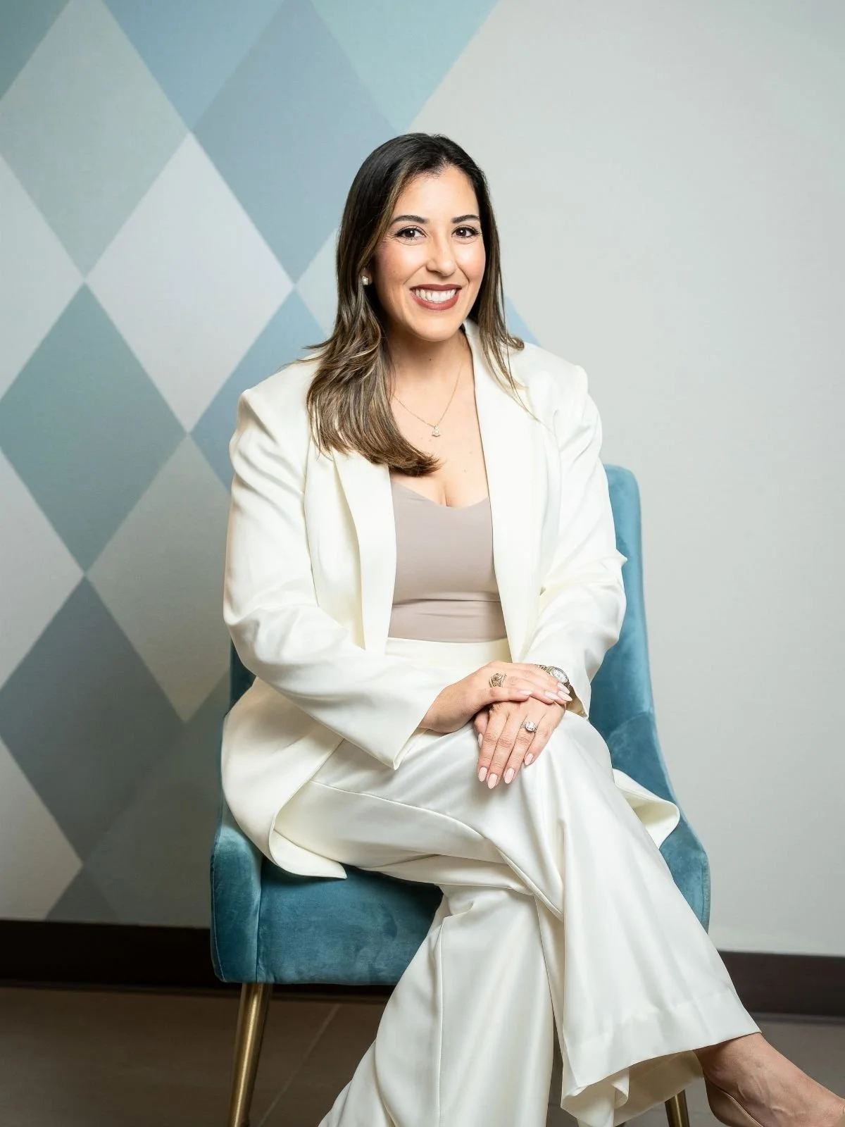Dr. Clarissa Salinas, founder of Heartsease Counseling Center, seated portrait.