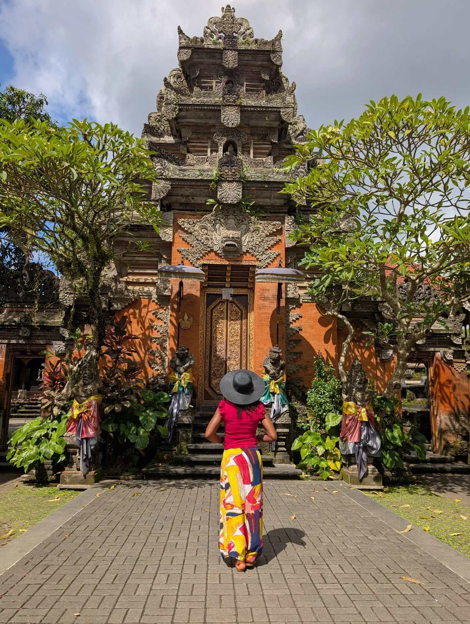 Guest exploring an ornate Balinese temple during the Blessed In Bali group travel experience by After Sunday