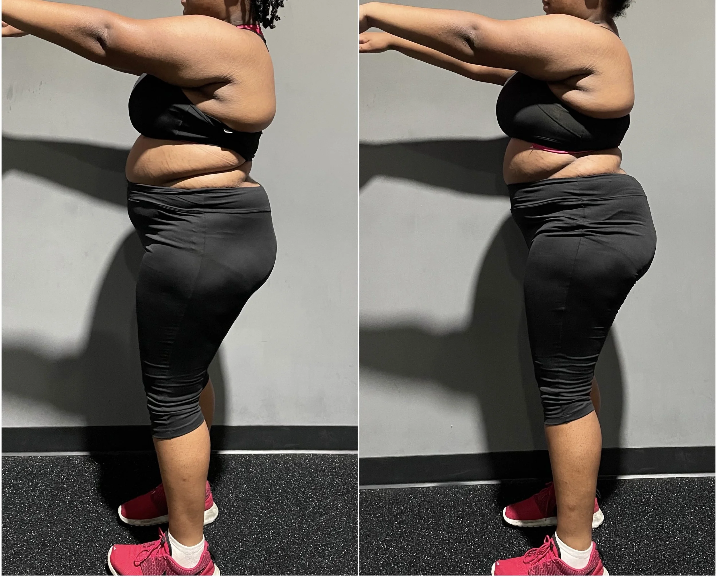 Side view of a woman performing a squat exercise against a gray wall. She wears black athletic leggings, a black sports bra, pink sneakers, and a pink sports bra underneath. The photo shows her bending her knees and hips while keeping her arms extend