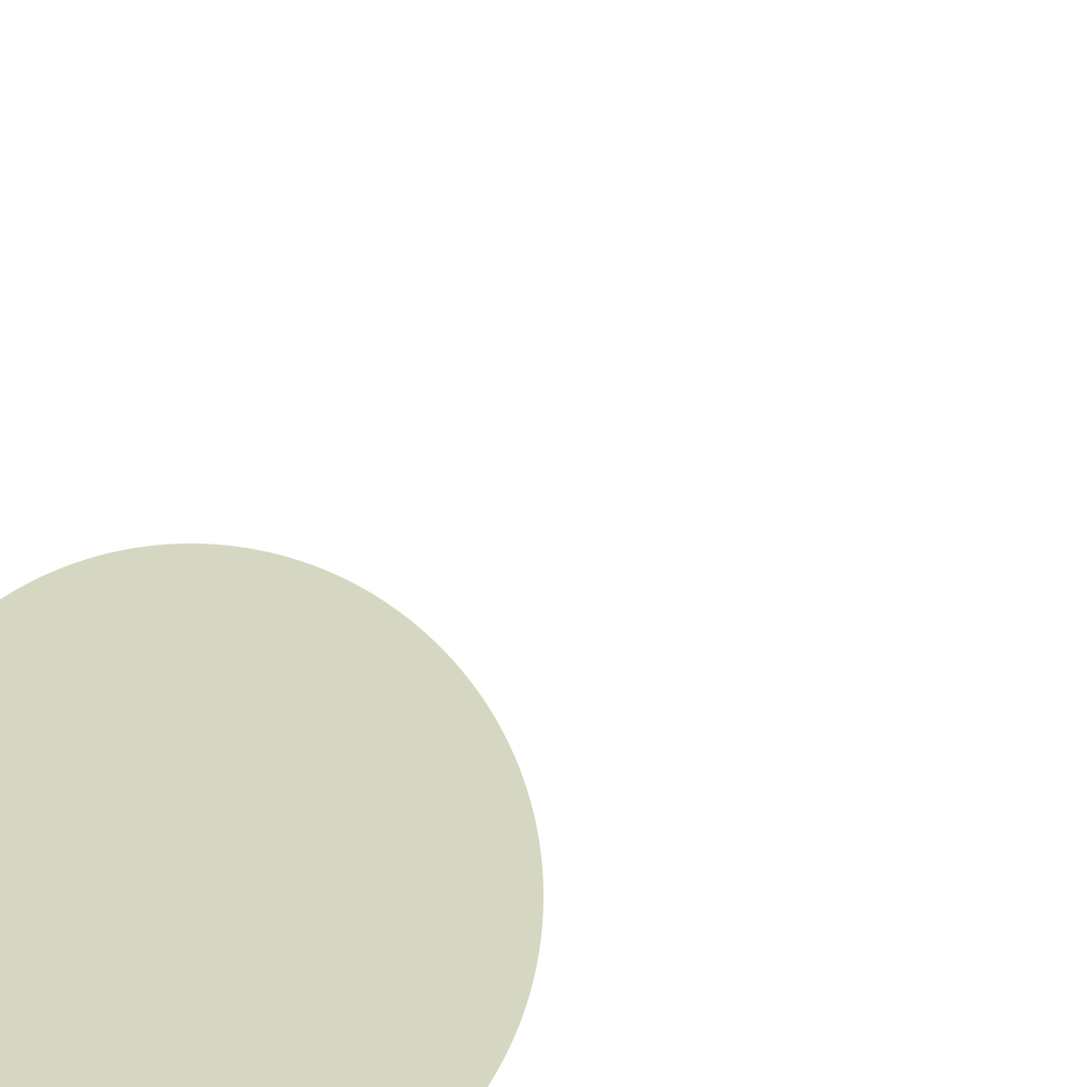 A close-up view of a large, pale yellowish-green ball with a smooth surface, positioned in the bottom left corner of the image against a black background.