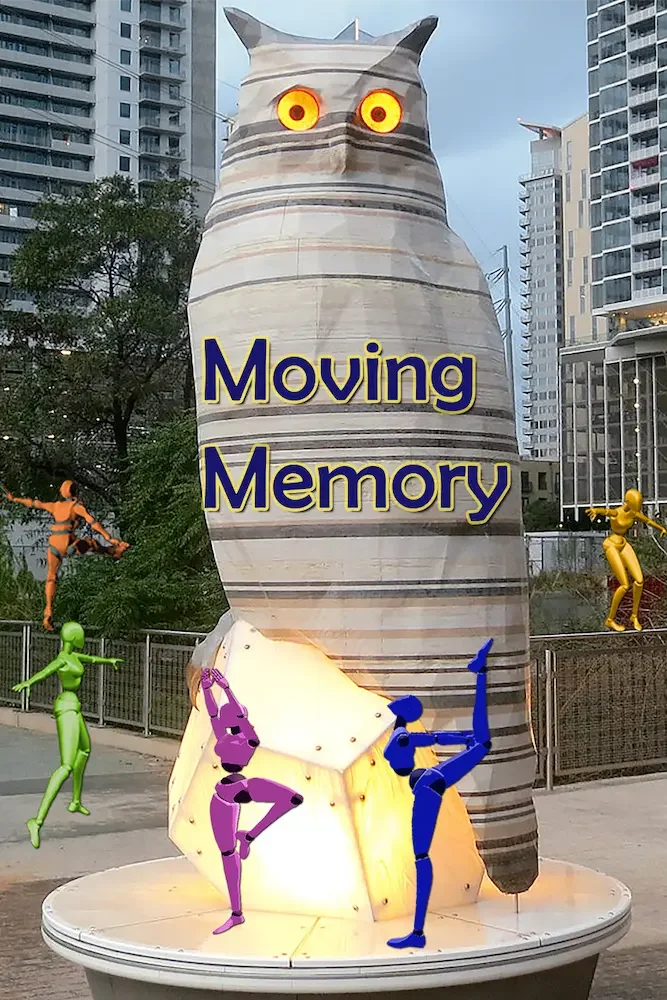 A large artistic sculpture of a cat with glowing eyes and the words "Moving Memory" on it, with colorful animated figure sculptures around it in an urban setting.