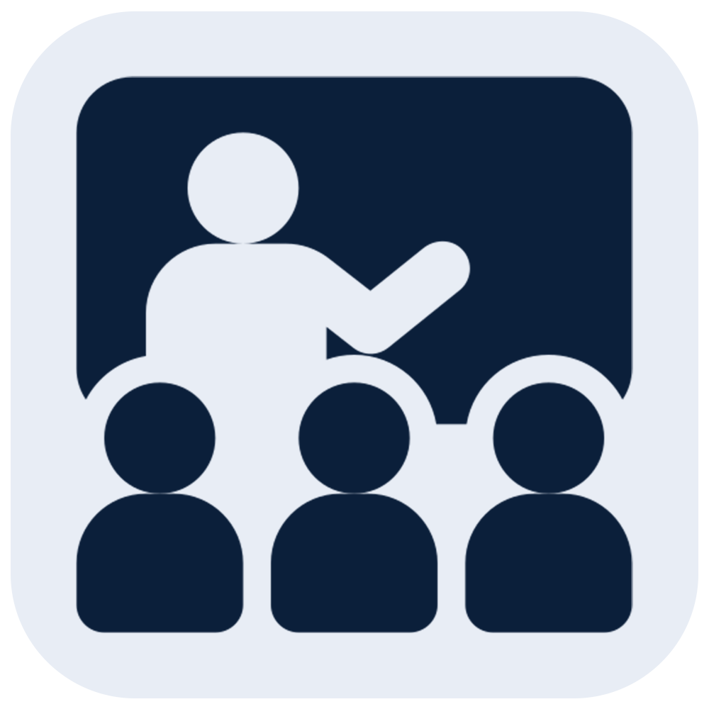 Icon of a person in a wheelchair giving a presentation to three seated people.