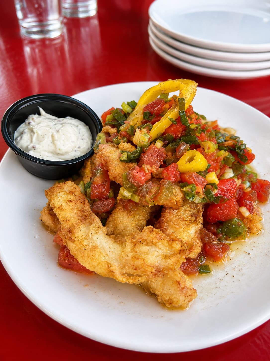 Crispy fried calamari with fresh bell peppers, a shareable tapas dish at Tapas & Tacos Beer Garden in Lake Leelanau, MI