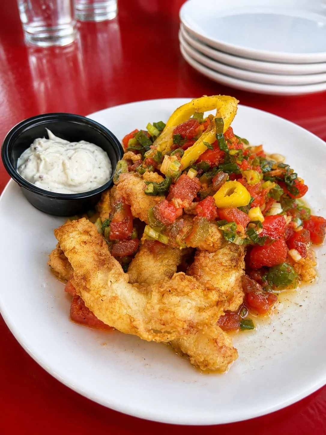 Calamari with diced peppers, onions, tomatoes, and white dipping sauce at Tapas & Tacos Beer Garden in Lake Leelanau, Michigan