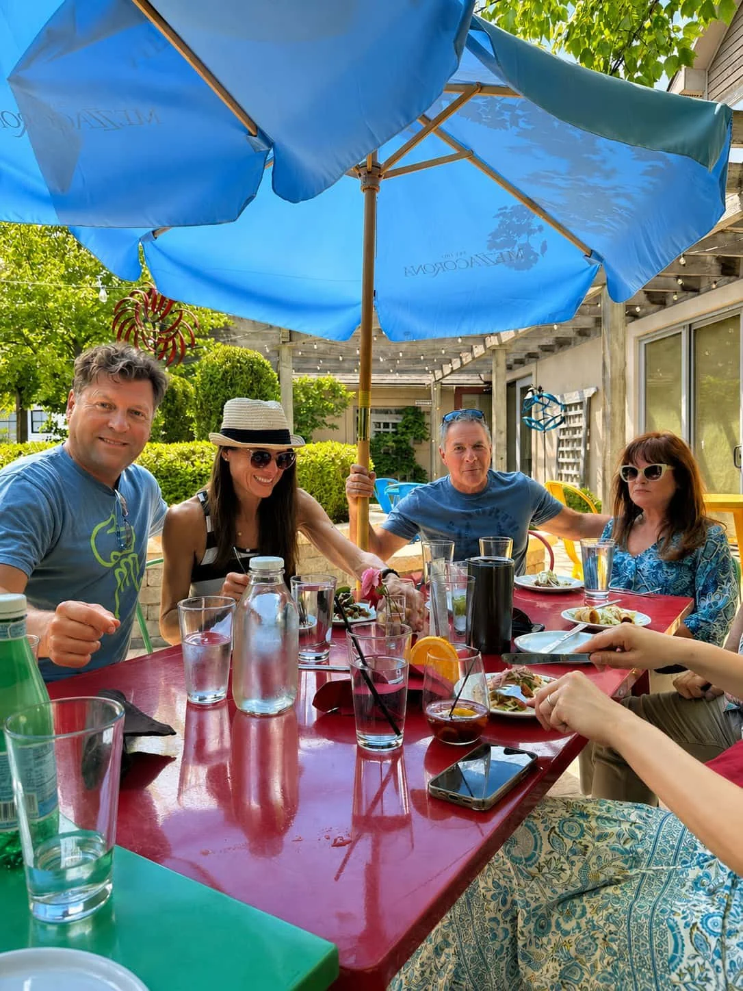 Guests enjoying happy hour and patio dining with drinks and food at Tapas & Tacos Beer Garden in Lake Leelanau, Michigan