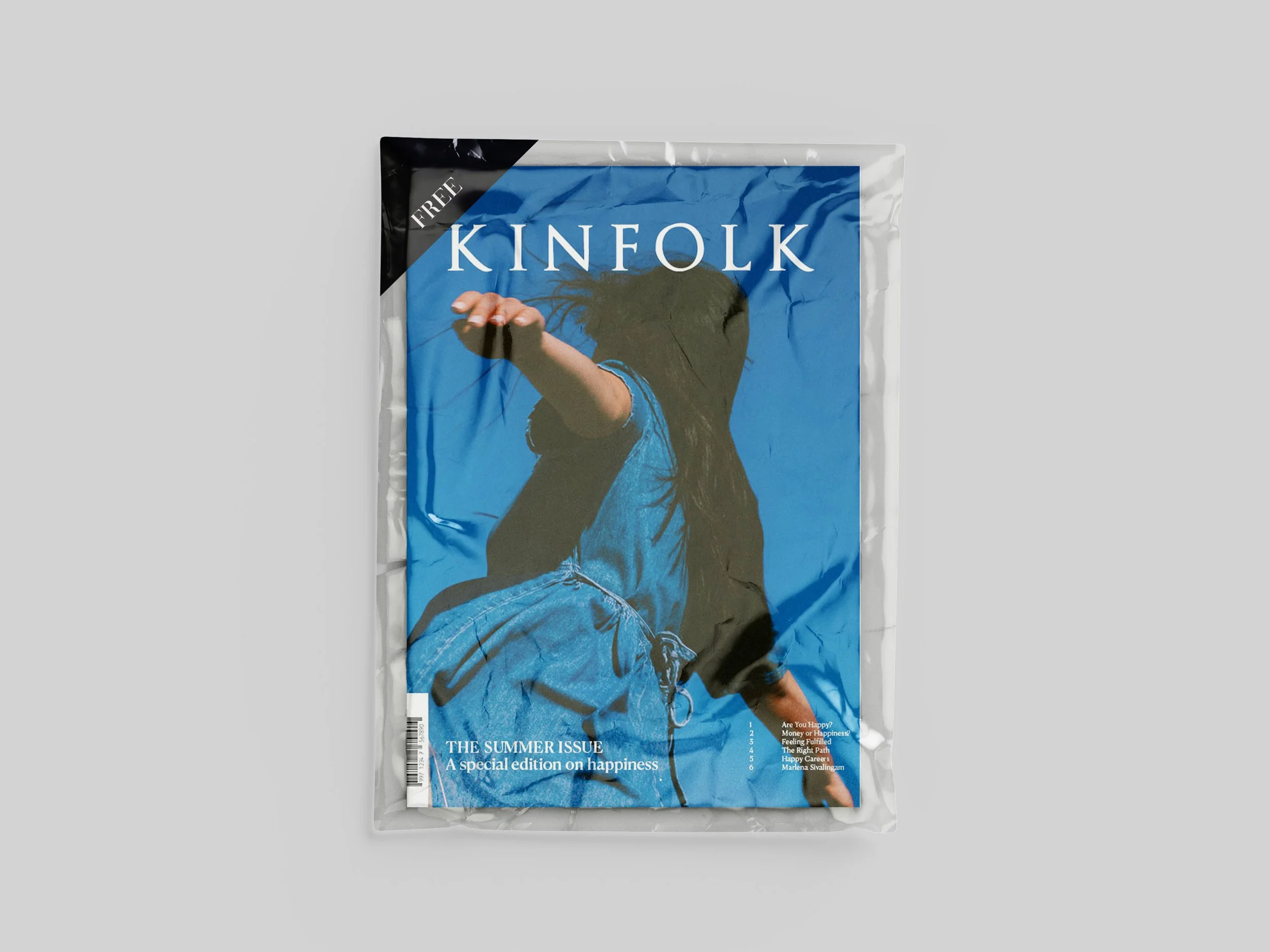 An image of Kinfolk Magazine in a plastic wrapper that says free on top left corner.