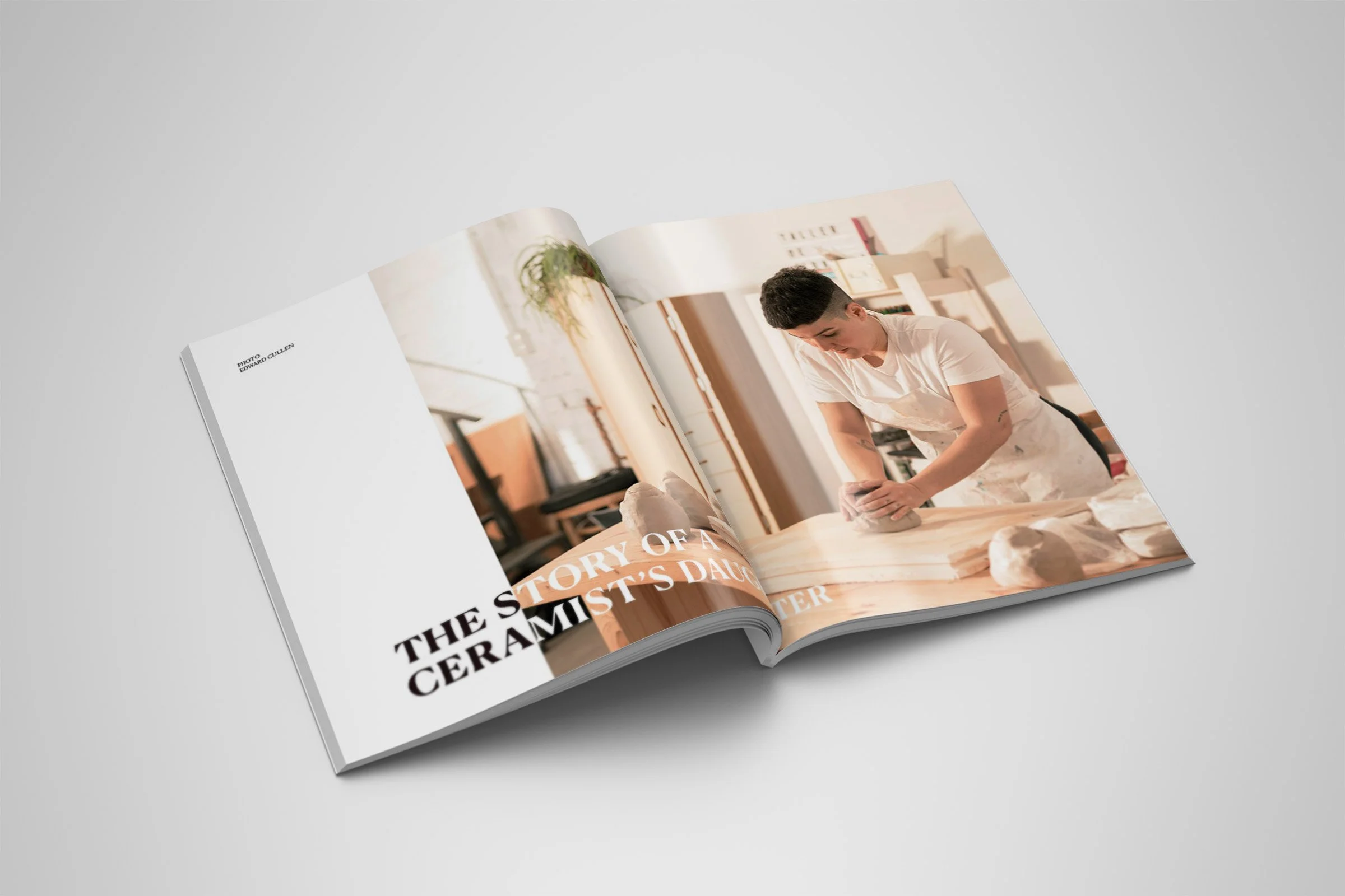 An open magazine spread of the cover story for the story of a ceramist's daughter where there is an image of a woman in a white shirt molding pottery clay.