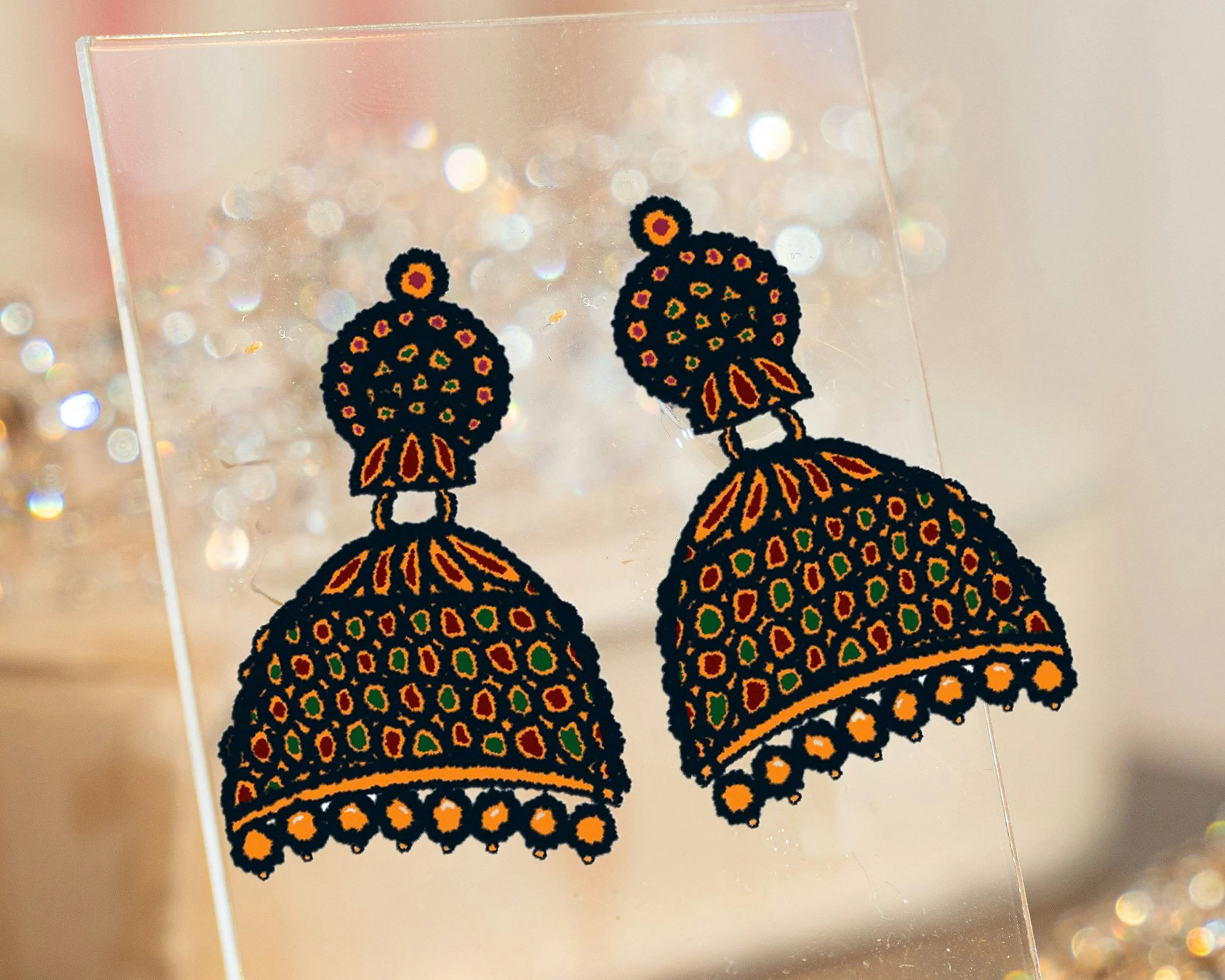 digital drawing of gold jhumki earrings with red and green jewels on a photograph of an earring stand nad light pink background and jewels