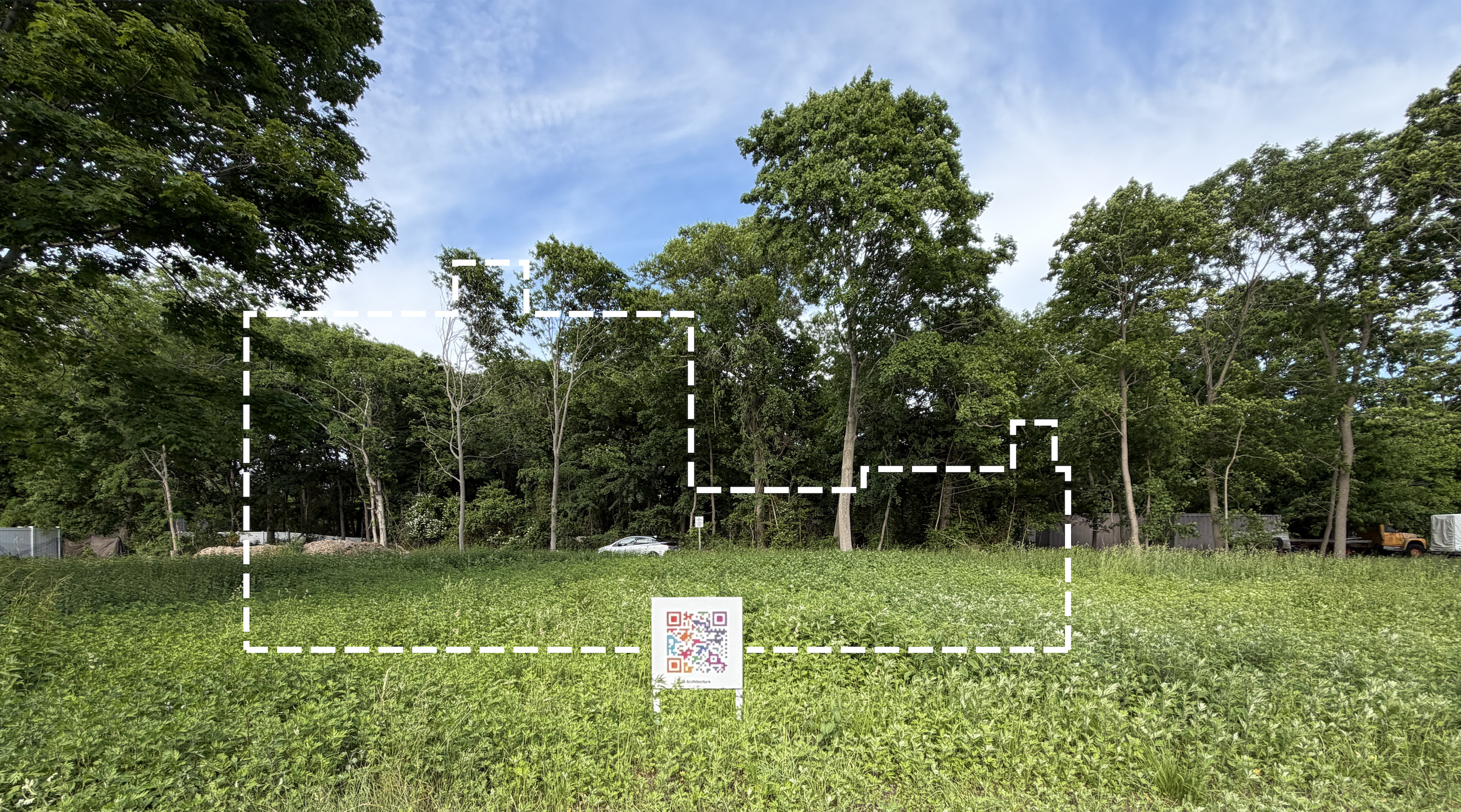 Site photo of the wedge-shaped Bellport lot with dashed Mod Spec house footprint