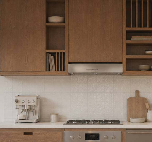 Kitchen with wooden cabinets, a coffee machine, a cutting board, and a stove.