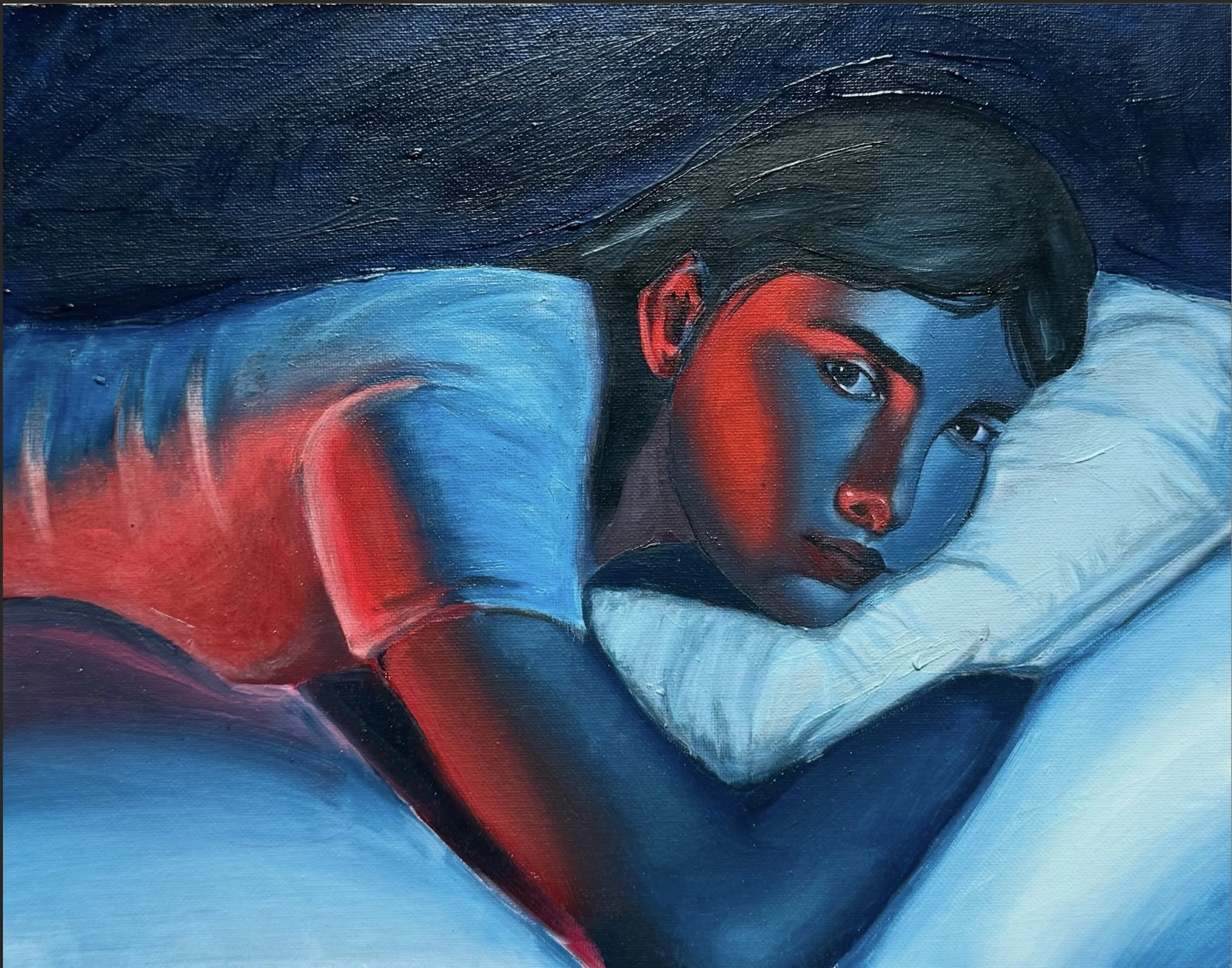 A close-up of a woman lying on a bed with red and blue light. 