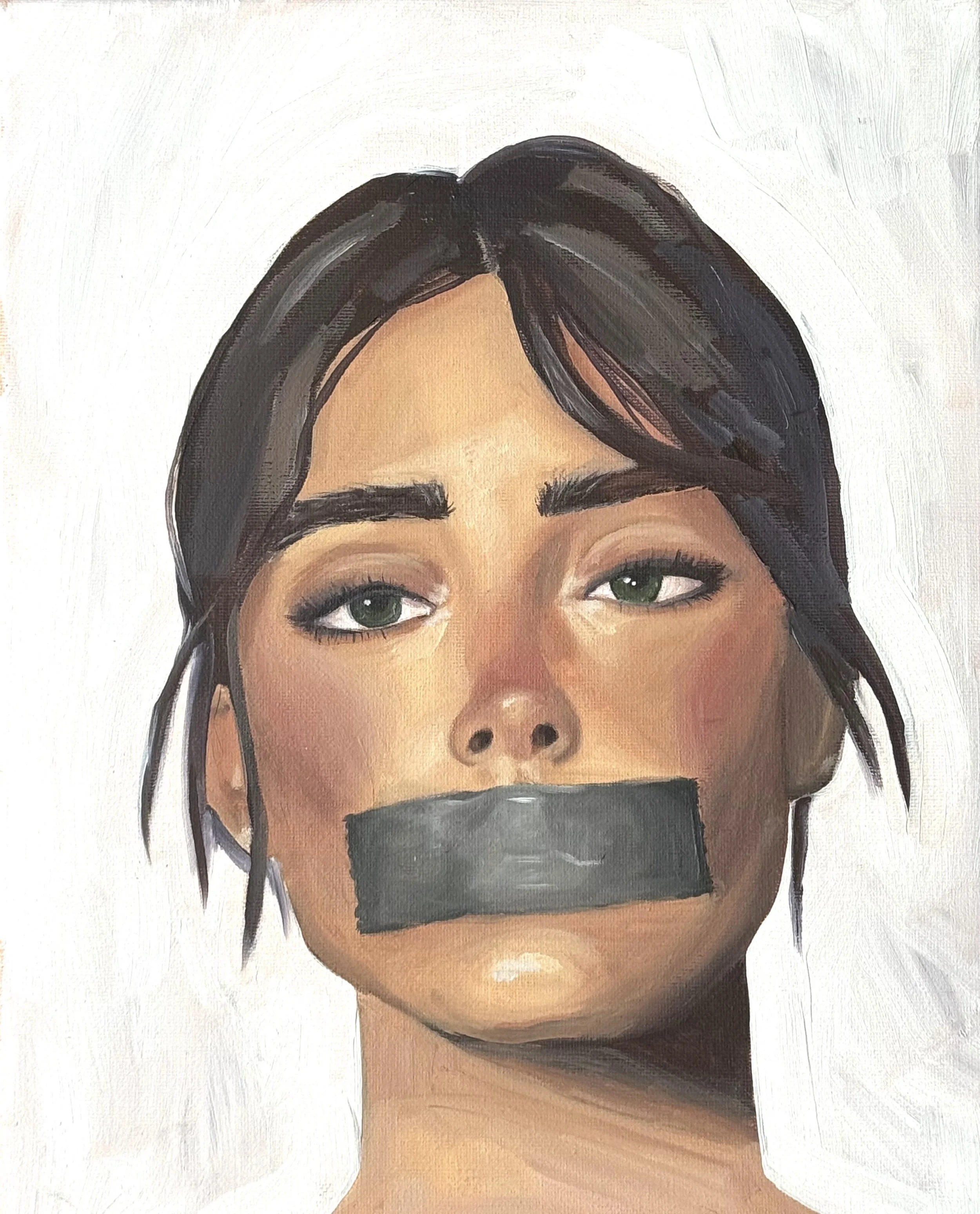 Close-up of a woman with dark hair and green eyes, with duct tape covering her mouth.