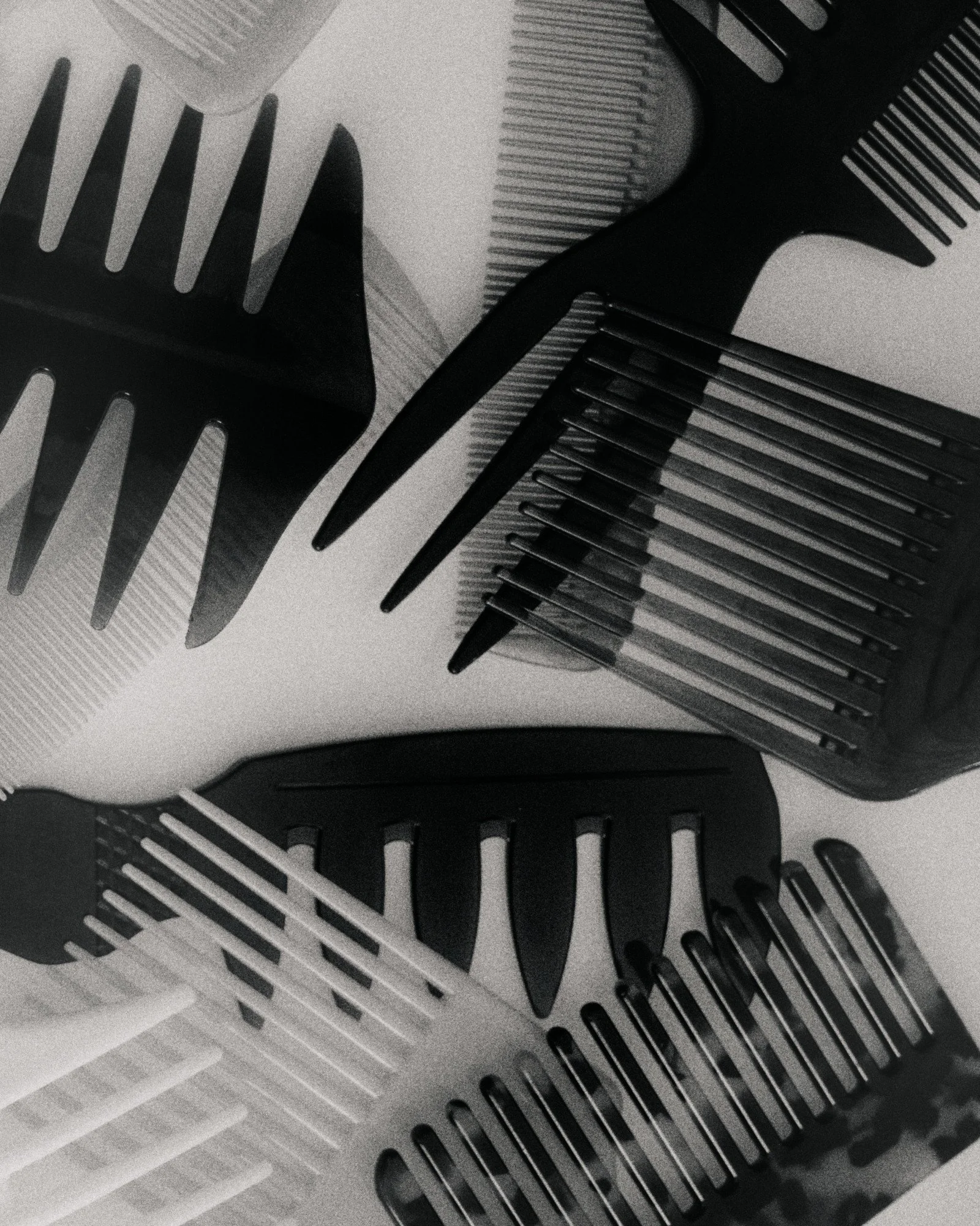 Close up black and white photo of hair dresser combs