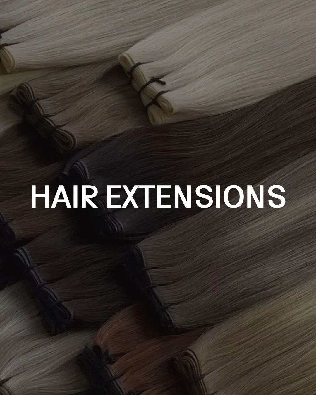 Multiple hair extension bundles in various shades of blonde and brown, tied with black bands.