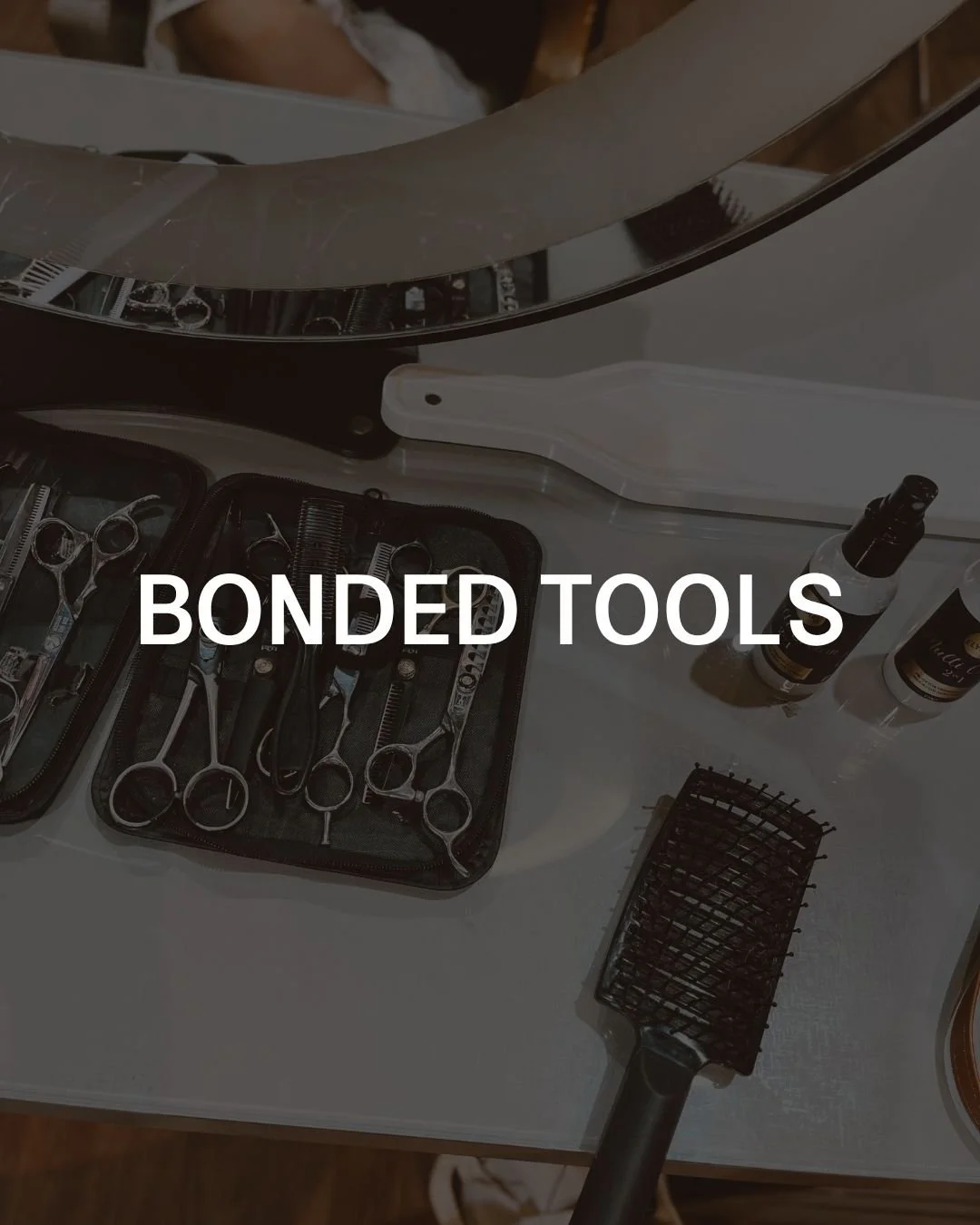 A collection of hairdressing tools including scissors, combs, and sprays on a white surface with the text 'Bonded Tools' overlayed.
