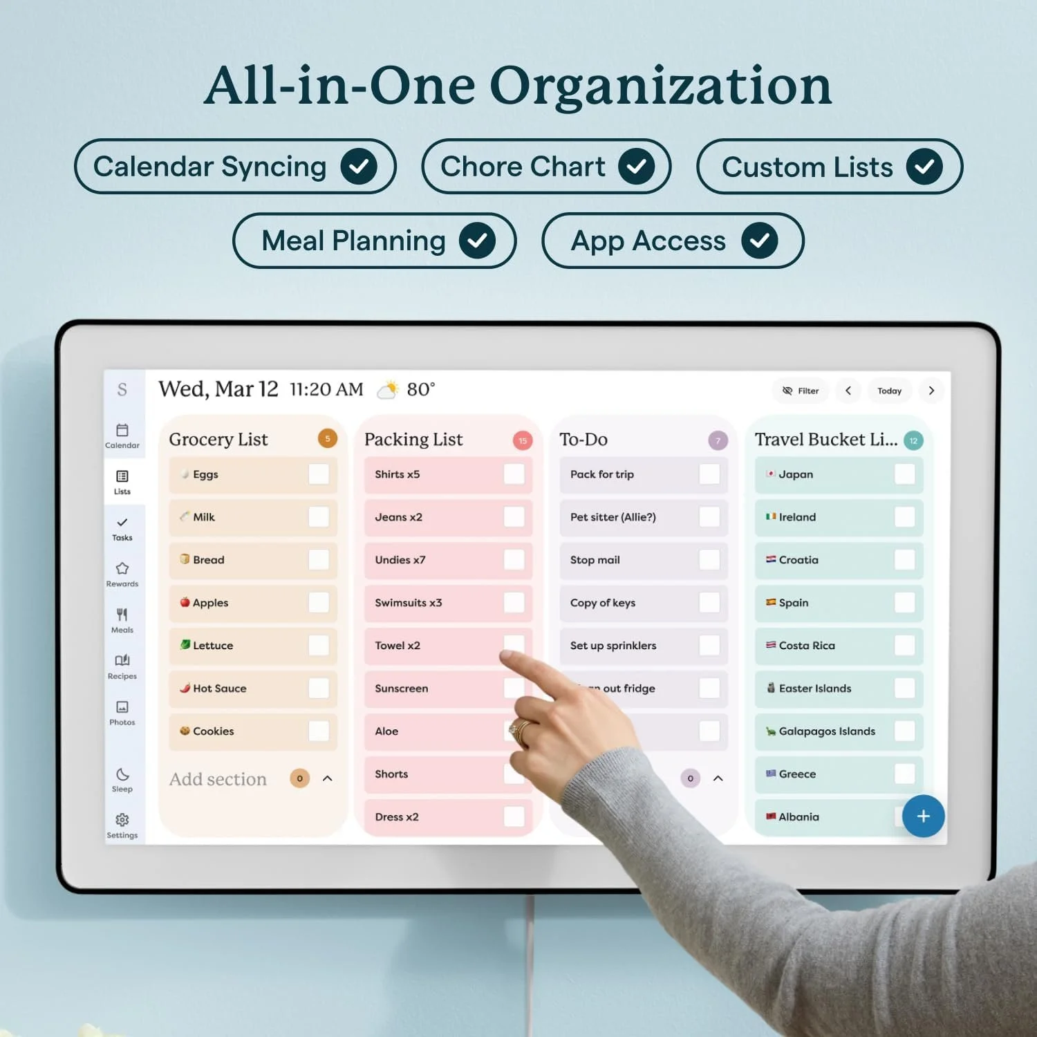 A digital organization tool displayed on a tablet screen, showing various lists including Grocery List, Packing List, To-Do list, and Travel Bucket List. A person's hand is pointing at items on the Packing List, which includes shirts, jeans, and other packing items. The interface has icons on the side for calendar, lists, tasks, rewards, meals, recipes, photos, sleep, and settings.