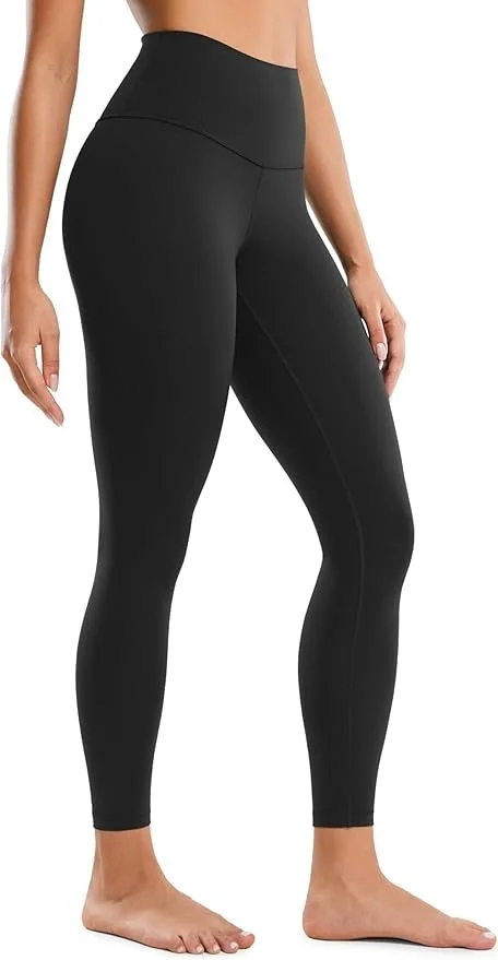 Close-up of a woman's lower body wearing black high-waisted leggings, standing barefoot.