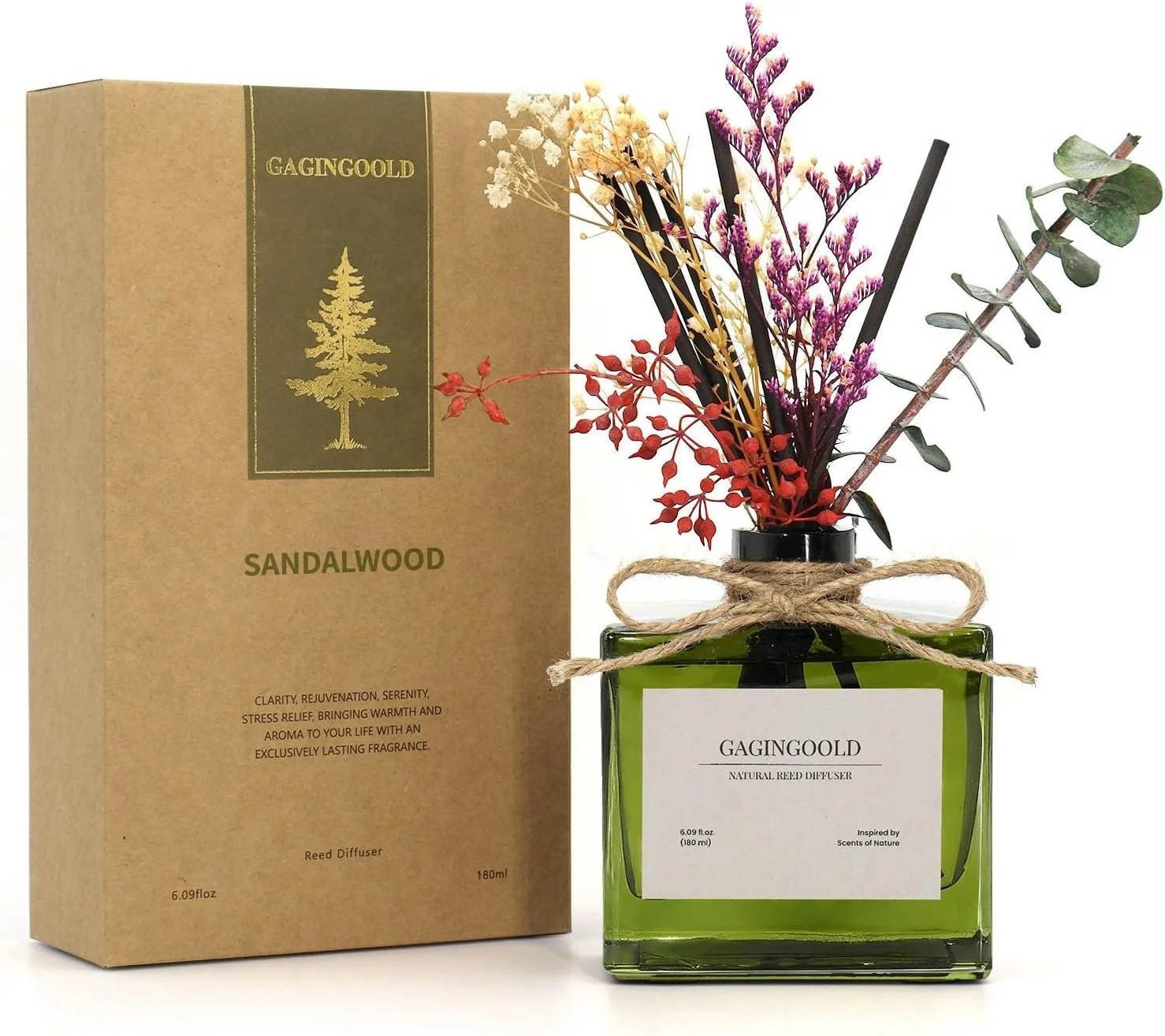 A green glass diffuser bottle with dried flowers, tied with a twine bow, beside a cardboard box labeled GAGINGOLD Sandalwood. The box mentions clarity, rejuvenation, serenity, stress relief, warmth, aroma, and lasting fragrance.