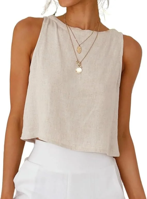 Woman wearing a sleeveless beige top with two layered gold necklaces, paired with white pants.