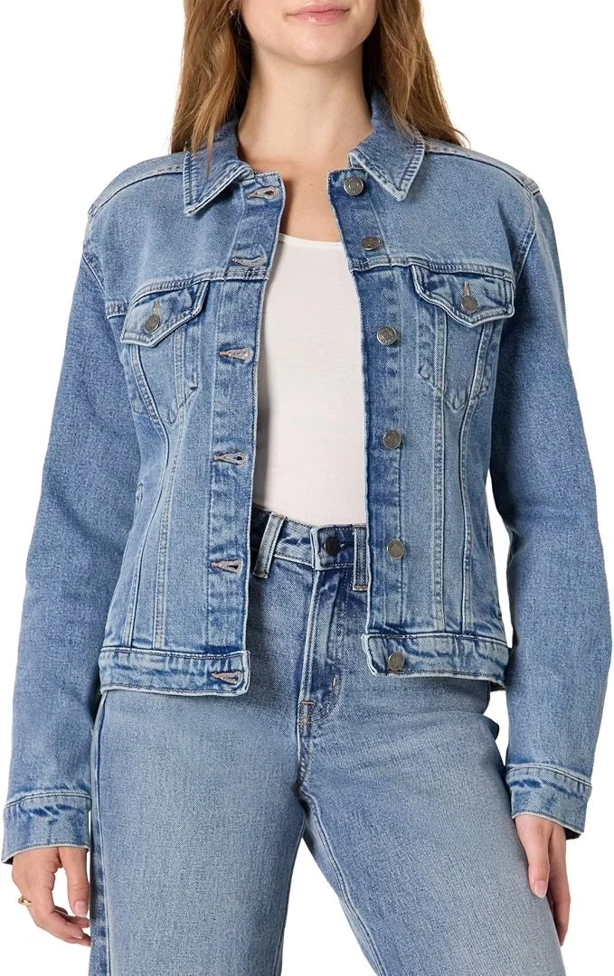 A woman wearing a light blue denim jacket, a white T-shirt, and matching light blue jeans.
