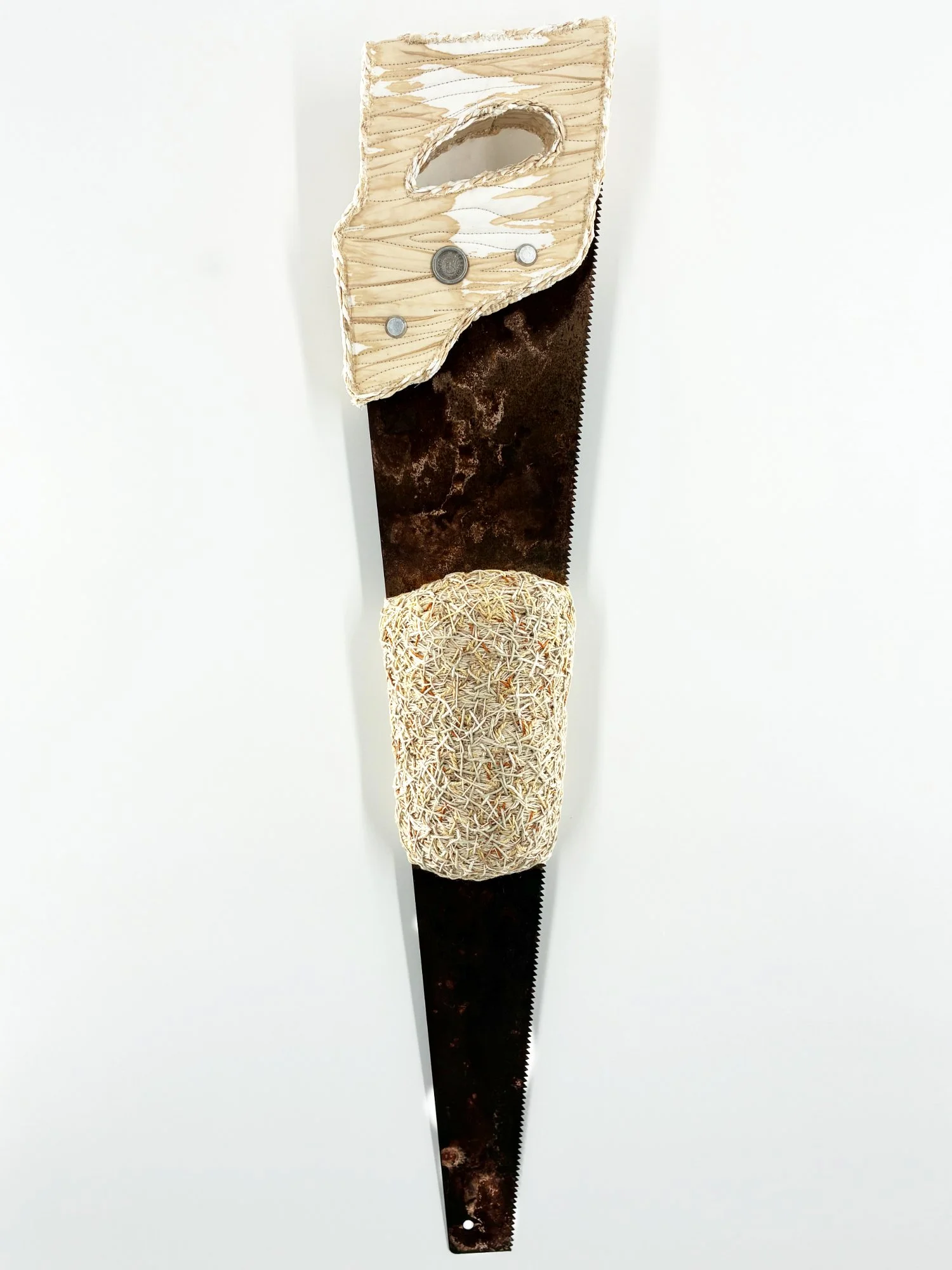 rusty hand saw wrapped in yarn and embroidered to show emotional labor