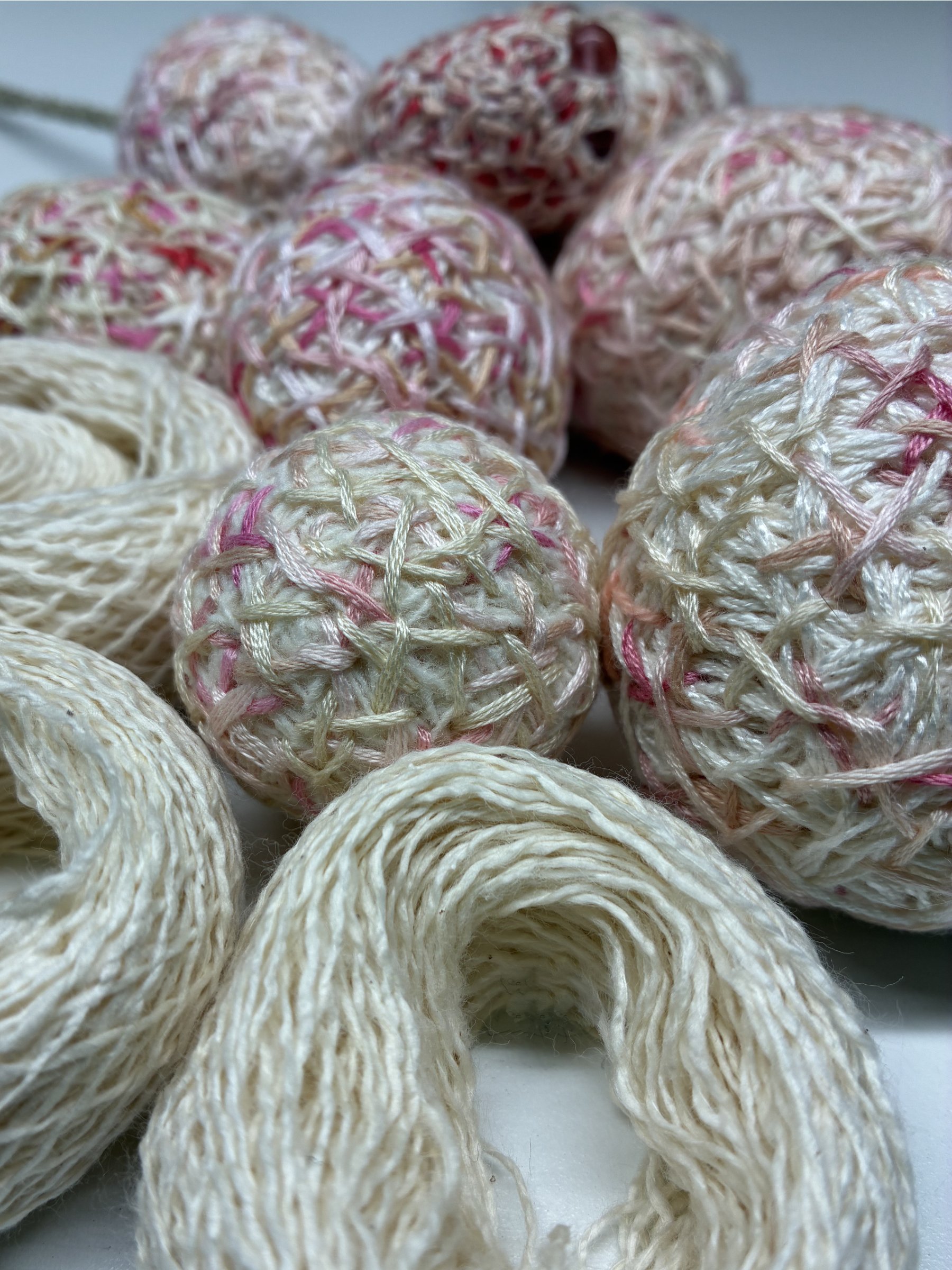 Finished cocoons and lace-weight yarn from a workshop