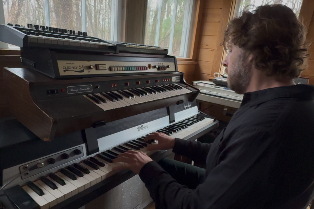 Songwriter and producer Itaal Shur playing electric organ in the studio.