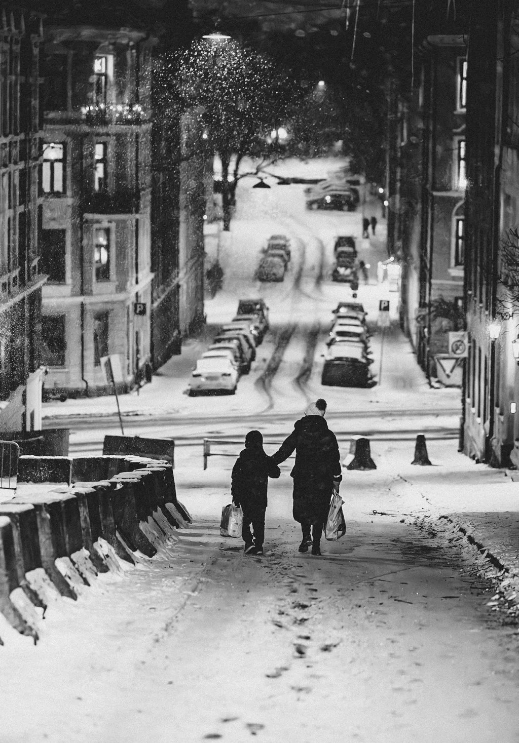 The Long Way Home — two figures walking through a quiet snow-covered street.