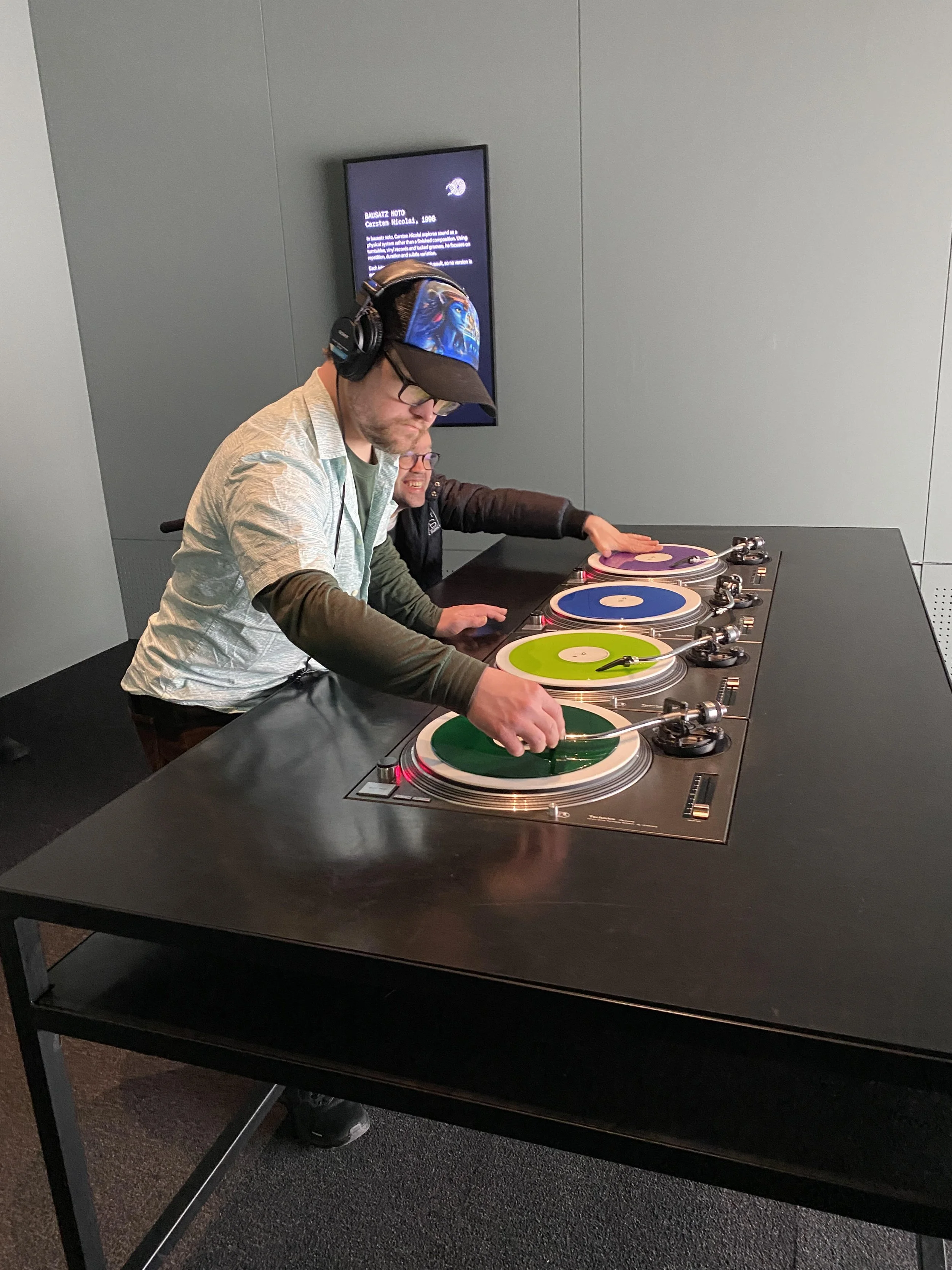 Daniel and Michael interacting with the record installation at ACMI