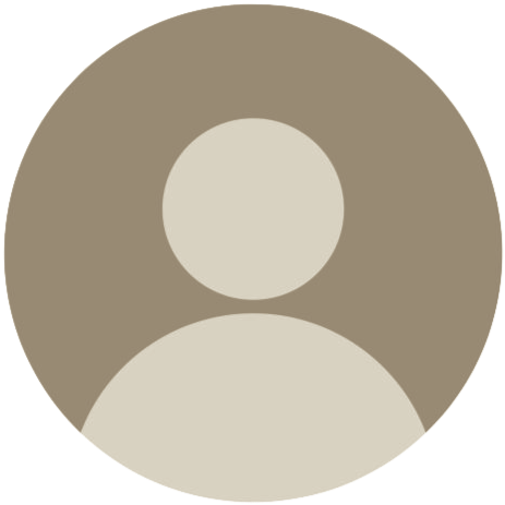 Generic user profile avatar with a circular gray and beige silhouette of a person on a gray background.