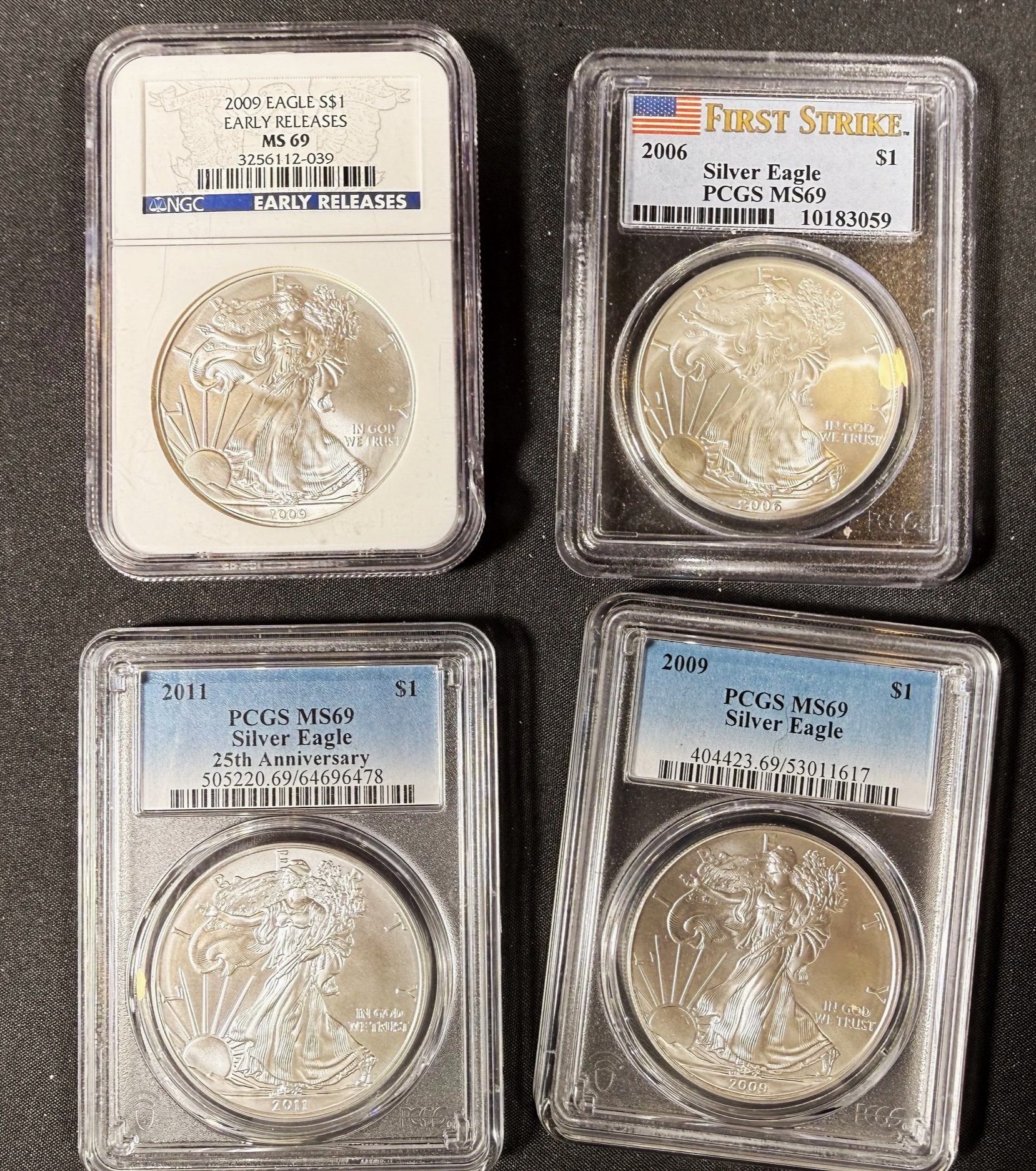 Silver American Eagle coins in protective cases, with labels indicating mint years of 2009, 2006, and 2011, and grades of MS 69 and PCGS MS69.