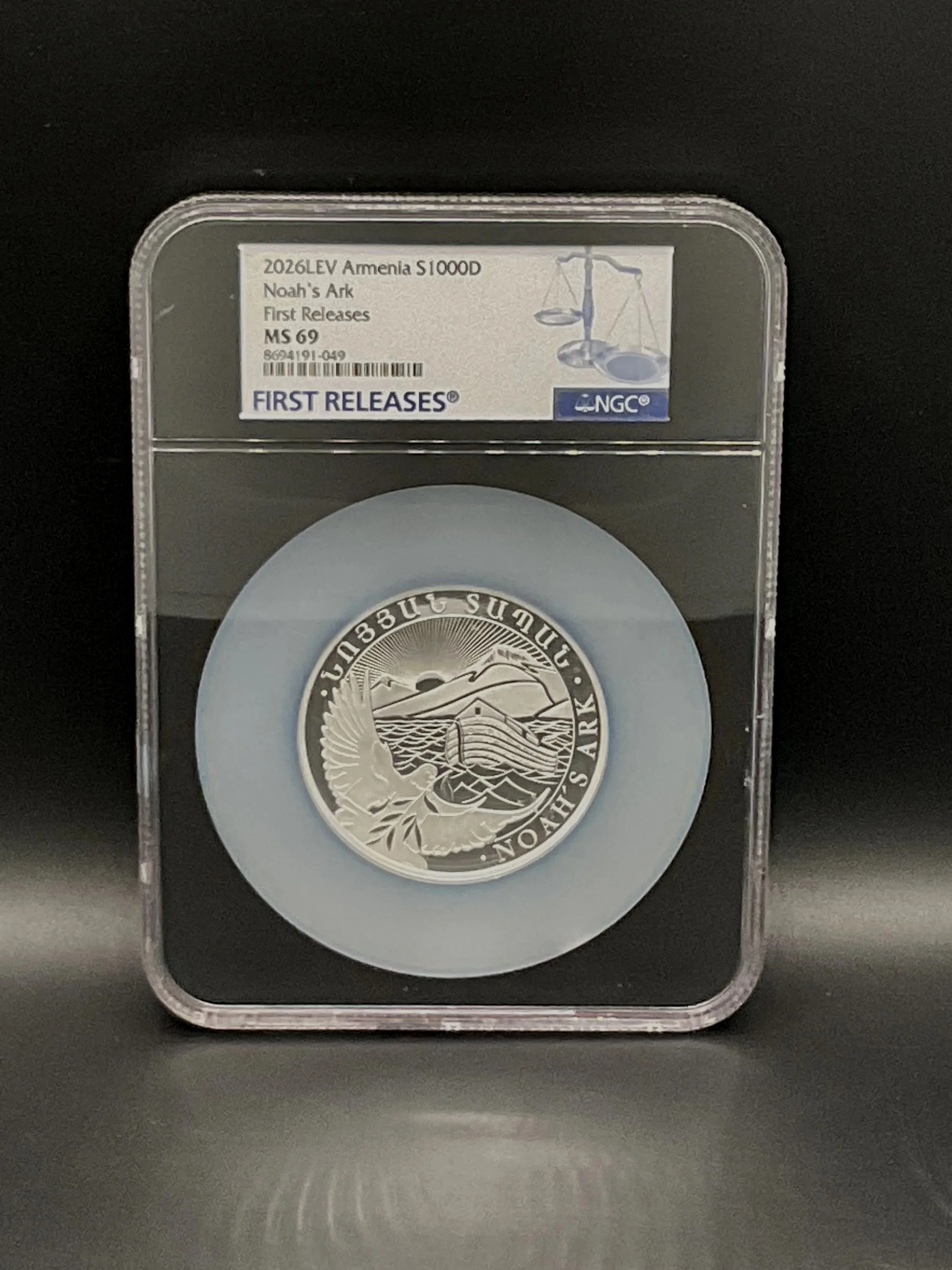 A silver coin in a clear plastic slab with a label reading '2026LEV Armenia S 1000D Noah's Ark First Releases MS 69' and a barcode. The coin features an engraved image of Noah's Ark with mountains and water in the background.