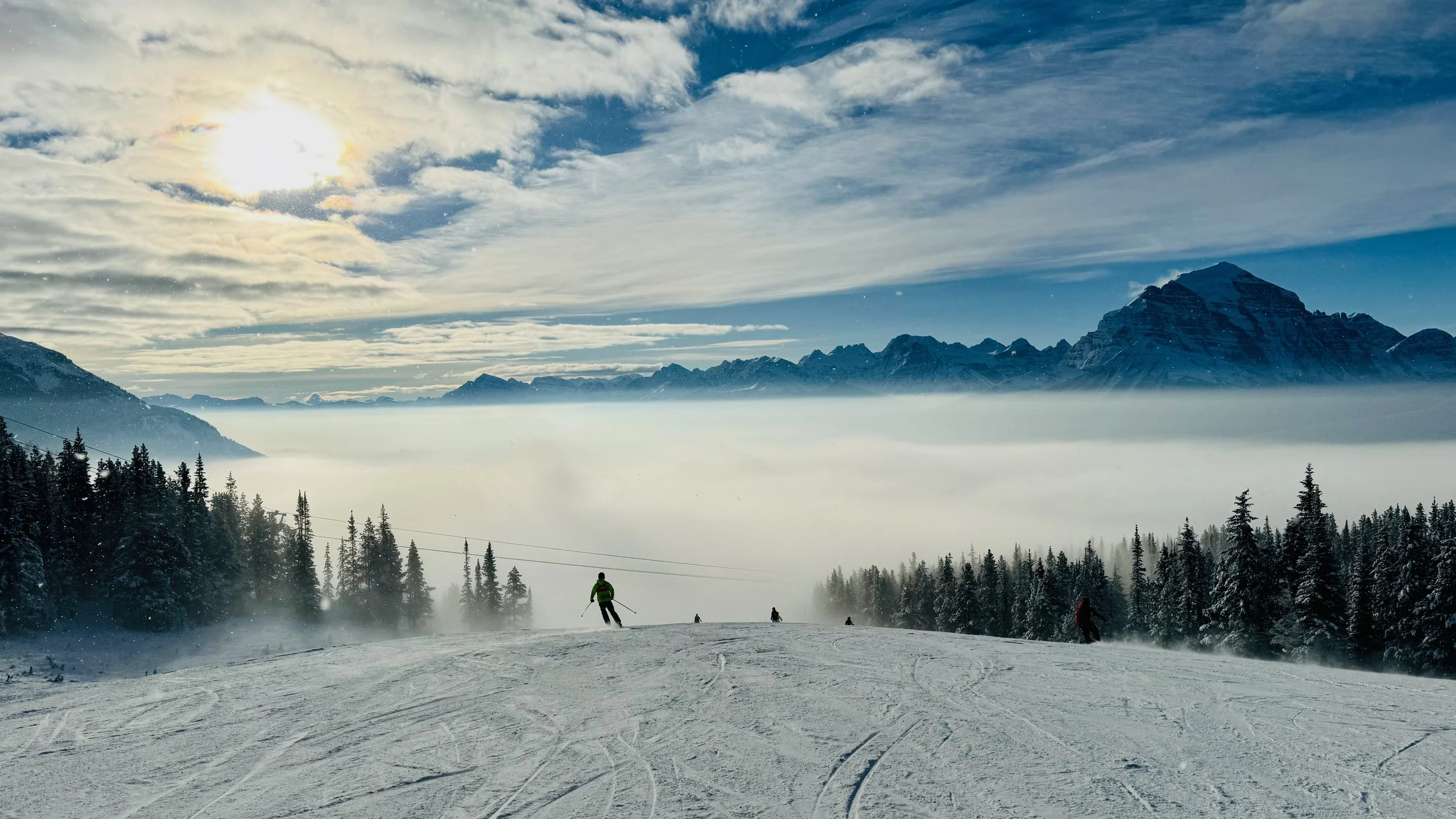 Skier descending trail into clouds at Lake Louise Ski Resort in Banff Canada