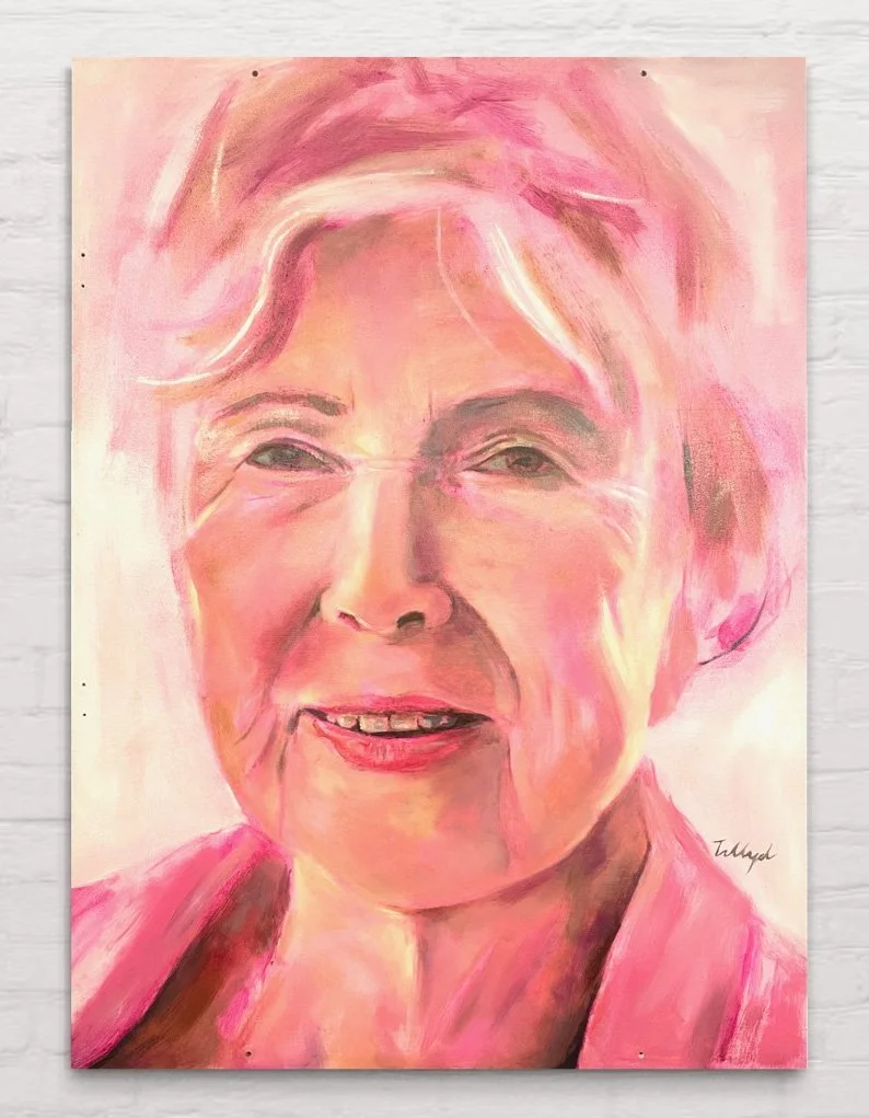 An oil painting portrait of an elderly woman with short, light-colored hair, smiling and wearing a pink top.