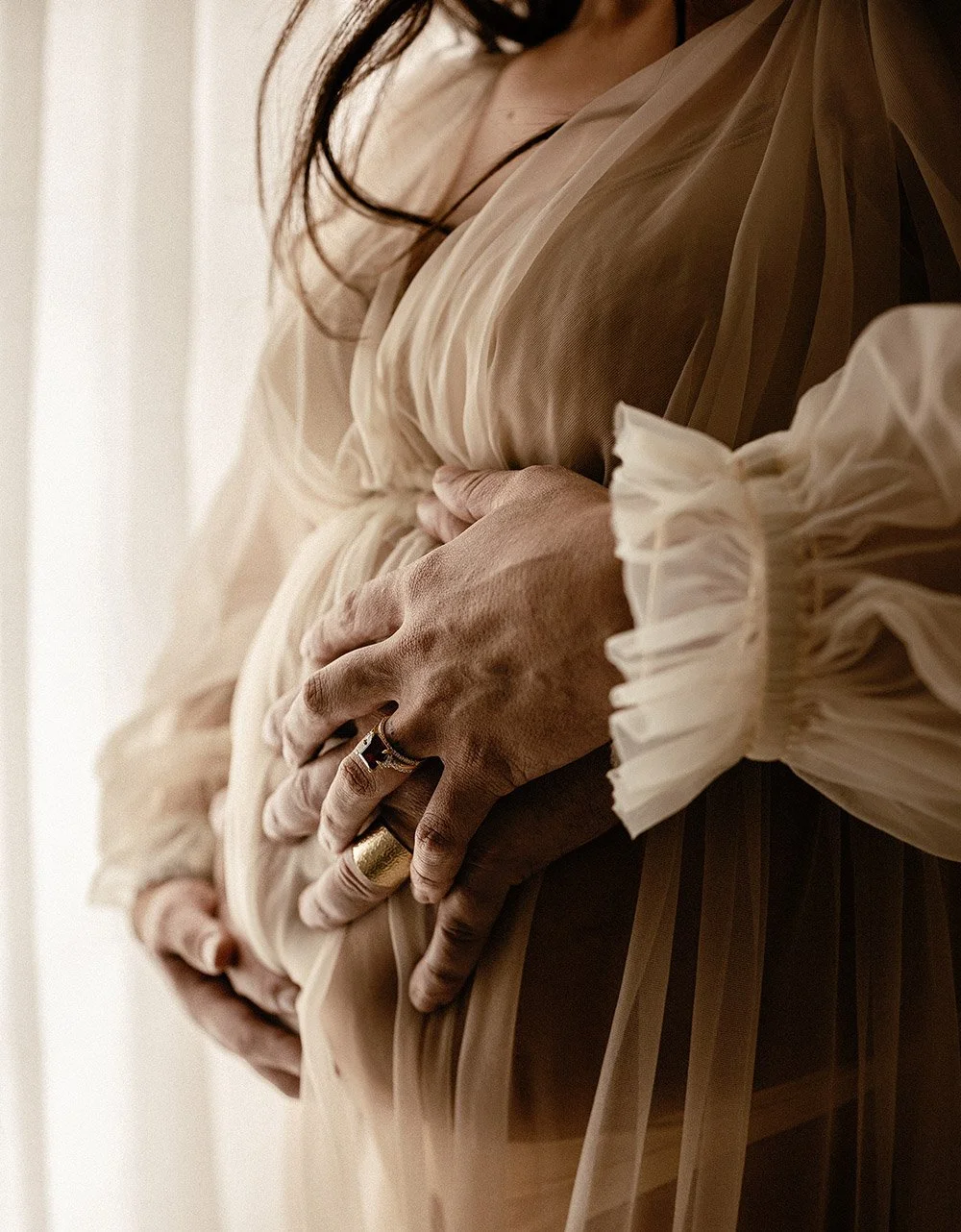 A pregnant woman's belly in a studio for a maternity photo shoot. Captured by Cody, Darwin.