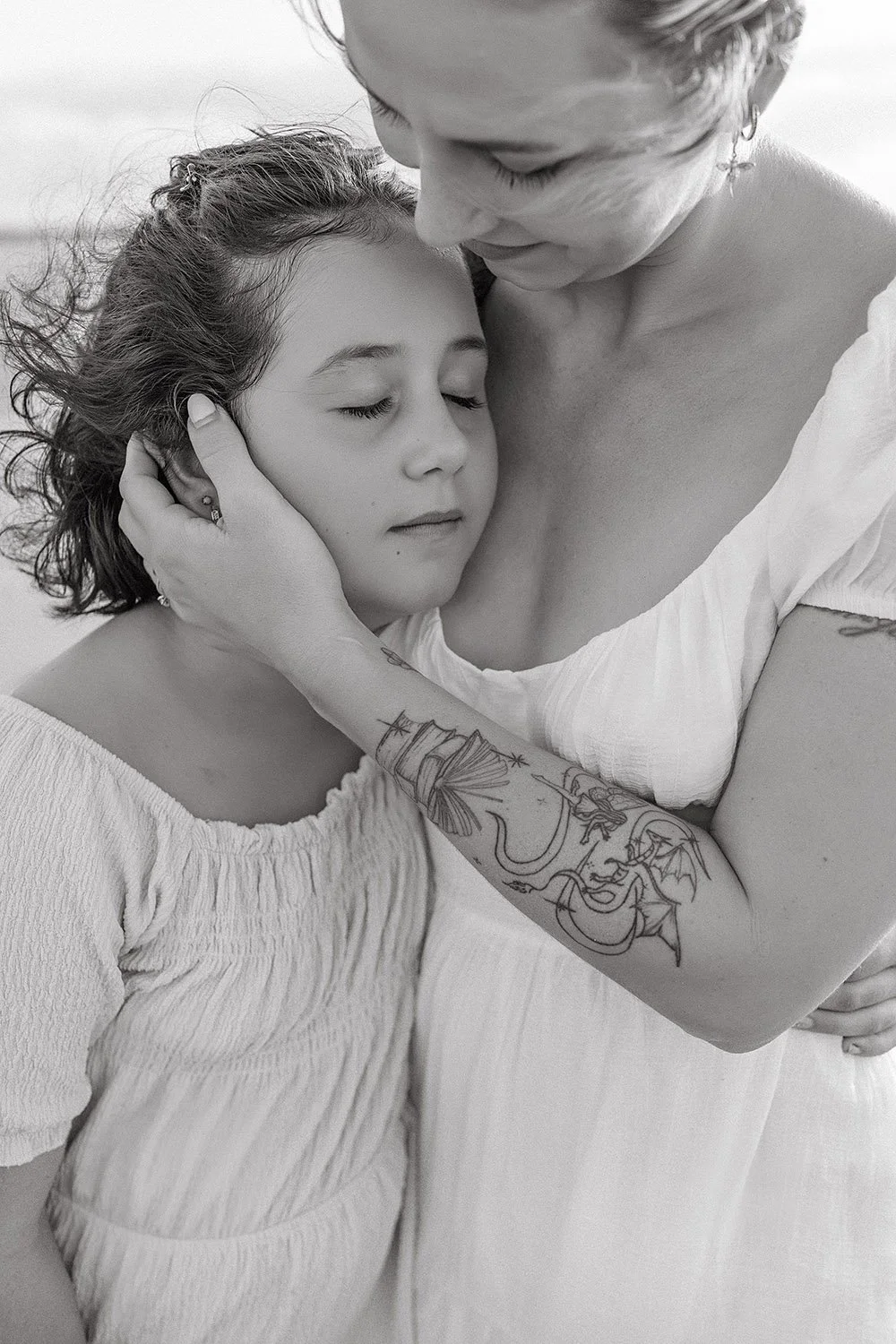 A mother holding her daughter on the beach in Darwin, NT. Family photographer, Captured by Cody, Darwin NT.