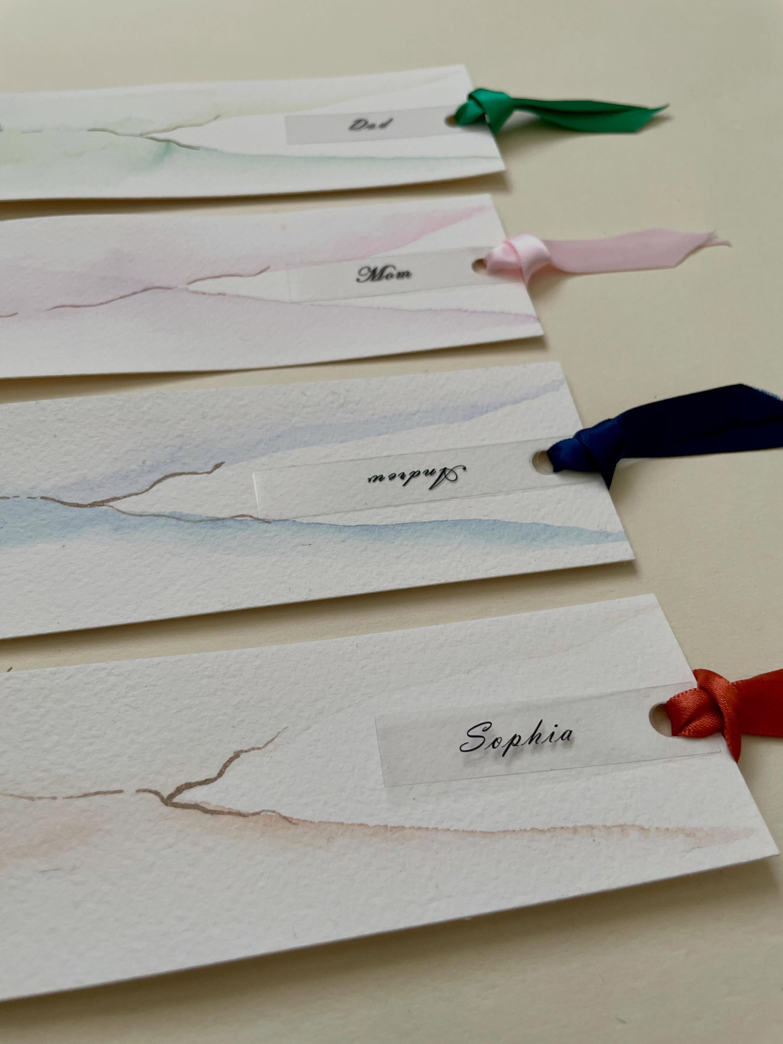 Long after the flowers have faded and the candles have gone out...

your guests will still have a small piece of your day.

Hand-painted wedding bookmarks designed as place cards and cherished as keepsakes.

Every brushstroke is unique. Every name te
